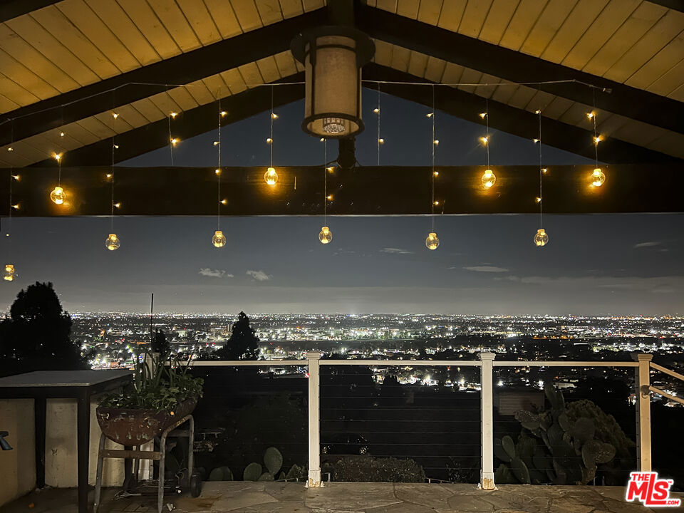 Enjoy breathtaking panoramic views from nearly every room in this elegant hillside home in Torrance's sought-after Valmonte neighborhood. Approx. 2,739 sqft per assessor, the home offers soaring ceilings, two living areas with fireplaces, a formal dining room, and a main-level primary suite with an en-suite bath and walk-in closet. The updated kitchen features generous counter space and custom cabinetry, flowing into the dining and patio areas ideal for entertaining. A flexible bonus room can serve as an office, gym, or guest space. Step outside to a stone patio with BBQ and firepit, all overlooking stunning city and mountain vistas. Upgrades include copper plumbing, newer HVAC, and a replaced sewer line. Close to scenic trails, top schools, and the South Bay coast.