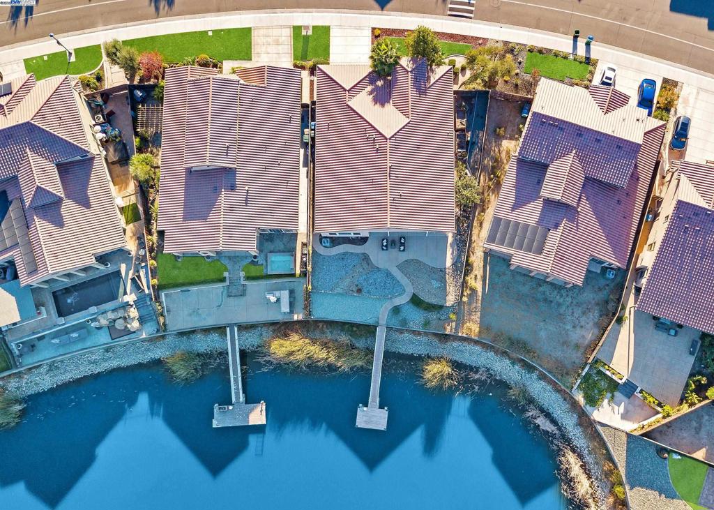 Lakefront Living – Rare Single-Story with Private Dock in Oakwood Shores! Welcome to your dream home in prestigious, gated Oakwood Shores! This stunning 2,719 sq ft single-story lakefront property offers 3 bedrooms + office, a private dock with water and electricity, and direct lake access—perfect for boating, fishing, and enjoying life on the water. Built in 2014 and designed for comfort and entertaining, the home features a freshly painted interior, a spacious kitchen/family room combo with granite countertops, a large island, gas stove, recessed lighting, and a full pantry. The primary suite opens to a covered patio with sweeping lake views—your own private retreat. Indulge in the luxurious Safe Step Tub & Shower with air therapy, hydro massage jets, heated seat, and aromatherapy. Head out from your private dock—equipped with water and electricity—for an evening paddleboat ride or cruise in your electric boat. Oakwood Shores offers low HOA dues, including a secured gated entrance, 24-hour private guard service, pool, and clubhouse. Minutes from Hwy 5 for an easy Bay Area commute, and close to shopping, dining, parks, Costco, and more. This rare gem won’t last—don’t miss your chance to enjoy the ultimate lakefront lifestyle!