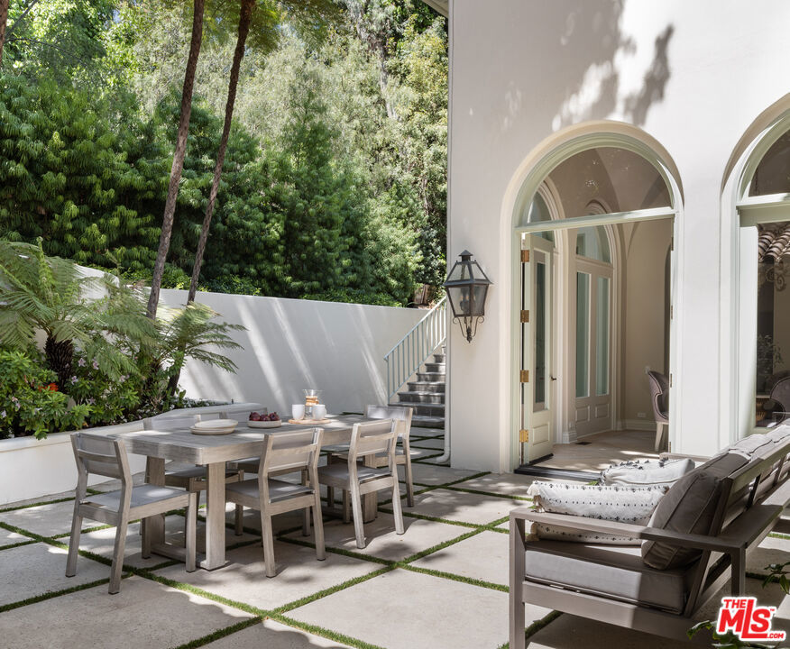 Accessed via a long tree-lined driveway set behind gates in the heart of prime Lower East Gate Bel Air awaits this meticulously designed Italianate estate with finely manicured gardens sited on over an acre. Few homes evoke tranquility like this luxurious and incredibly private oasis surrounded by mature landscape. Grounds include a swimming pool, spa, tennis court, and ample parking. Formerly "The Lee Iacocca Estate", the property is rich in pedigree, entertaining Hollywood's elite, Frank Sinatra, Priscilla Presley, Ronald Reagan, Barbara Davis, Betty White, Bob and Dolores Hope, to name a few. Enter a grand foyer featuring double height ceilings, a wood-paneled den, six bedrooms, eight bathrooms. Second level consists of three large en-suite guest rooms accompanied by a grand primary suite with its own living area, dual bathrooms, large walk-in closets, and picturesque balconies. The bright and recently updated kitchen features state of the art appliances, chef prep area, temperature controlled wine room, and easy access to both the formal and casual dining rooms. This exceptional home connects seamlessly to its lush grounds and exemplifies the perfect blend of formal and relaxed California living with the convenience of the fully serviced wellness and culinary experiences at Hotel Bel Air steps away.
