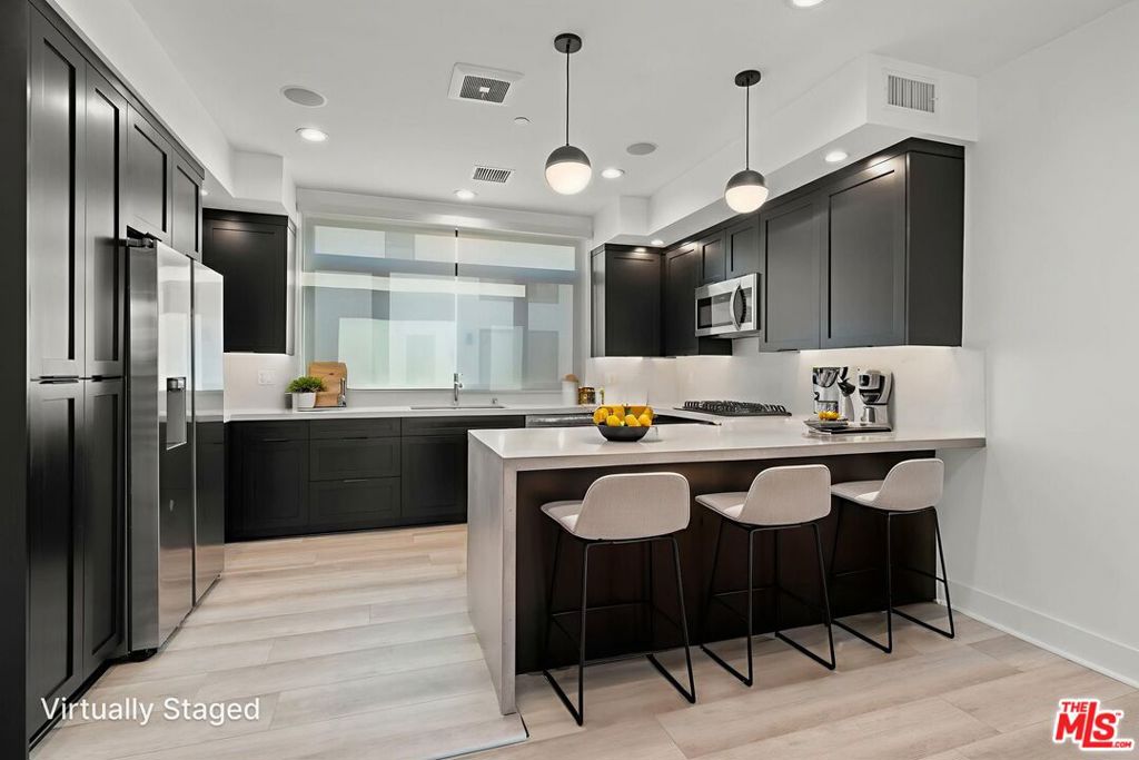 ** PET FRIENDLY ** WASHER/DRYER ** CENTRAL A/C ** PRIVATE GARAGE ** LARGE PRIVATE ROOFTOP DECK ** MODERN LIVING ** Welcome to 11304 Victory Blvd, a beautifully designed and modern 3-bedroom, 3-bathroom single-family home offering 1,624 sq ft of thoughtfully crafted living space in the heart of North Hollywood. Perfectly blending style, comfort, and convenience, this residence is ideal for those seeking a vibrant lifestyle with easy access to the best of the San Fernando Valley. Step inside to an inviting open-concept main level, where natural light pours in through dual-pane windows, illuminating the spacious living room and dining area. The sleek, modern kitchen is a true showpiece, featuring stainless steel appliances, ample cabinetry, and contemporary finishes, perfect for both everyday living and entertaining. From here, enjoy seamless access to a private balcony, extending your living space outdoors for morning coffee or evening relaxation. Upstairs, the expansive primary suite feels like a private retreat, complete with a luxurious en-suite bathroom featuring dual sinks, a walk-in closet, and a large private balcony to enjoy fresh air and city views. The lower level offers flexibility with a junior suite that includes its own en-suite bath, along with a third spacious bedroom and a nearby full bathroom ideal for family, guests, or a home office setup. Additional highlights include a private front yard, central HVAC for year-round comfort, an in-unit washer and dryer, recessed lighting, and a versatile bonus room off the attached 2-car tandem garage that can be used as a home gym, office, or extra storage. Located in a prime North Hollywood neighborhood, this home places you just minutes from the exciting new NOHO West development, the lively Arts District, Burbank Airport, and major freeways, making commuting and exploring Los Angeles a breeze. With trendy dining, shopping, and entertainment at your fingertips, this move-in-ready home offers the perfect balance of modern luxury and everyday convenience. Square footage may include garage - tenant pays utilities.