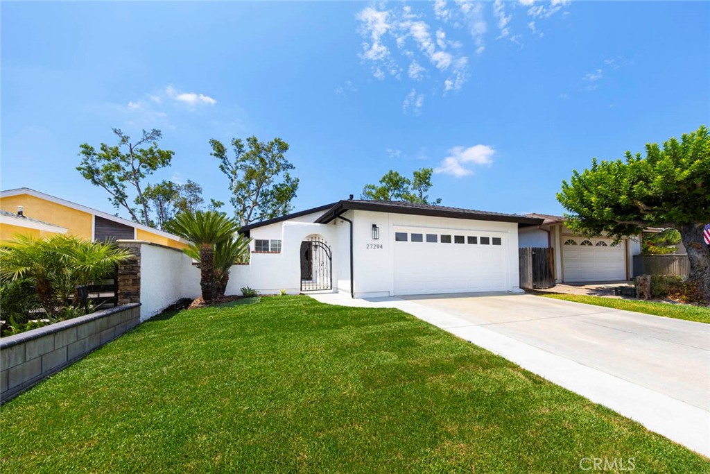 Welcome to this beautifully updated and reimagined single-story 4 Bedroom home with a hacienda feel in the highly desired Cordova North neighborhood of Mission Viejo. Every inch has been thoughtfully designed and remodeled from top to bottom. This 4-bedroom, 2-bath residence offers approximately 1,475 square feet of modern living space on a 5,000 square foot lot. Step inside to discover a light-filled semi-open floor plan featuring new luxury vinyl wide plank flooring, a custom-designed fireplace surround, a new roof, new dual-pane windows & sliders, new insulation, ceiling fans, Shaker Style interior doors & cabinets, and a fully redesigned kitchen complete with quartz countertops, custom soft-close cabinetry, and stainless steel appliances. The Primary Suite includes a spacious walk-in closet and a beautifully renovated and enlarged Master Bathroom with dual sinks, a large walk-in shower w/built-in shampoo niche and custom tile. The second bathroom has also been tastefully updated with warm contemporary finishes and fixtures and a new tub. Enjoy serene tree-lined views including Saddleback Mountain and true indoor-outdoor living with a spacious southwest-facing backyard and large patio. Additional upgrades include a newer HVAC system, updated electrical switches and outlets, recessed lighting throughout, and interior direct access to a freshly coated epoxy garage floor that actually fits two cars. Located just minutes from Lake Mission Viejo, where your membership grants access to the beach, boating, concerts, fireworks, and a recreation center. You'll also love the close proximity to top rated public schools. Both Trabuco Hills High School and Del Lago Elementary are within walking distance as are shopping and dining options. Major transportation routes including the Toll Roads are within easy reach. This move-in ready home combines comfort, style, and an exceptional location-offering a turnkey opportunity in one of South Orange County's most desirable communities.
