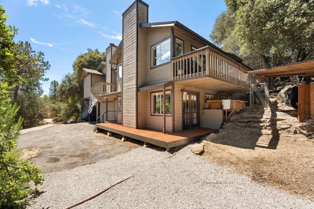 Experience refined living in the heart of Pine Valley with this exceptional multi-family retreat! Perfectly set on a picturesque .64-acre lot, the MAIN residence includes 4 bedrooms & 3 baths, featuring efficiency at its finest with 36 OWNED solar panels, dual-pane windows, & 4 cozy fireplaces. Large west-facing windows beautifully capture panoramic views of majestic oaks & pines, while expansive decks invite you to bask in endless sunsets. The updated kitchen, complete with soft-close cabinets, a large island, modern appliances, a wine fridge, & even a built-in beer tap, is a host’s dream. Retreat to the spacious master suite offering a private deck & opulent walk-in closet adorned with a chandelier. Essential updates such as laminate flooring & revamped bathrooms grace the home throughout. Enhance your living space with a fully accessible bonus room offering a fireplace, ideal for a 3RD RETREAT (rental) or hosting guests. For those seeking a versatile & fully-equipped mountain escape, this Pine Valley property extends its charm beyond the main home. A delightful 800 sq ft GUEST HOUSE, legally permitted, offers 2 spacious bedrooms, 1 full bath, & ample natural light. Enjoy the ambiance of a pellet stove & the inviting charm of a cozy covered front porch—perfect for sipping morning coffee or enjoying outdoor dining. An 11,000-watt Honda generator effortlessly powers both homes when needed, while designated RV parking w/30-amp elec & water ensures additional guest accommodations. **Situated in a community celebrated for its seasonal events, including car shows, parades, & holiday tours, Pine Valley offers proximity to I-8 for reliable Wi-Fi & cell service. With just a 20-minute drive to Julian/Lake Cuyamaca & 45 minutes to downtown, this move-in ready home promises a unique blend of natural beauty, versatility, & value.