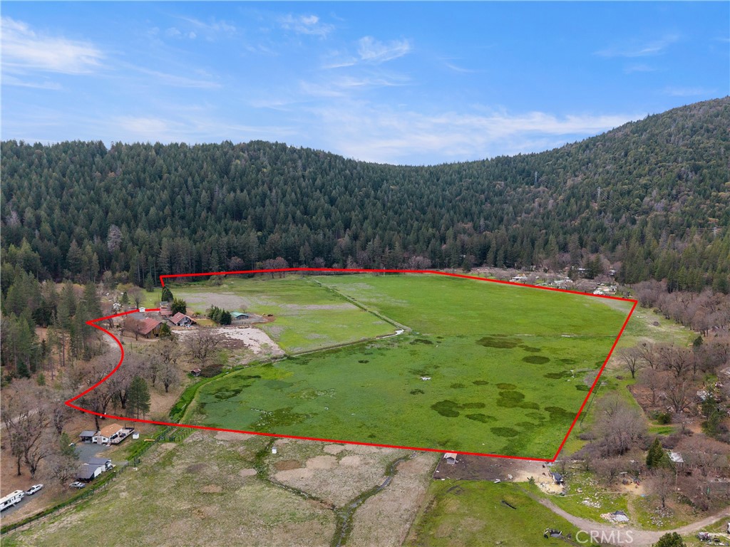 Salminas Meadow is a magical 50-acre pasture at the end of a box canyon. The headwaters of Cole Creek begin in a spring that gushes from a mountain at the SE corner of the property. The creek then runs north past some impressive old growth timber then through the center of the pasture on its way to Clear Lake. The Salmina family has owned this farm for generations. This is the first time it has ever been available for sale. Two small, rustic, farm homes come with it, as well as some romantic old barns built early in the 20th century. Water is supplied from a spring box developed decades ago along with a domestic well. Three-phase power is on site. A newer horse barn is used to shelter animals, and the field is fenced and cross-fenced. The sub irrigated field stays green year round. As you hike around the meadow, you can't help but notice the chips and flakes from Native American tools scattered everywhere. People have been in love with this magnificent setting for thousands of years. You will love it too as soon as you get there.