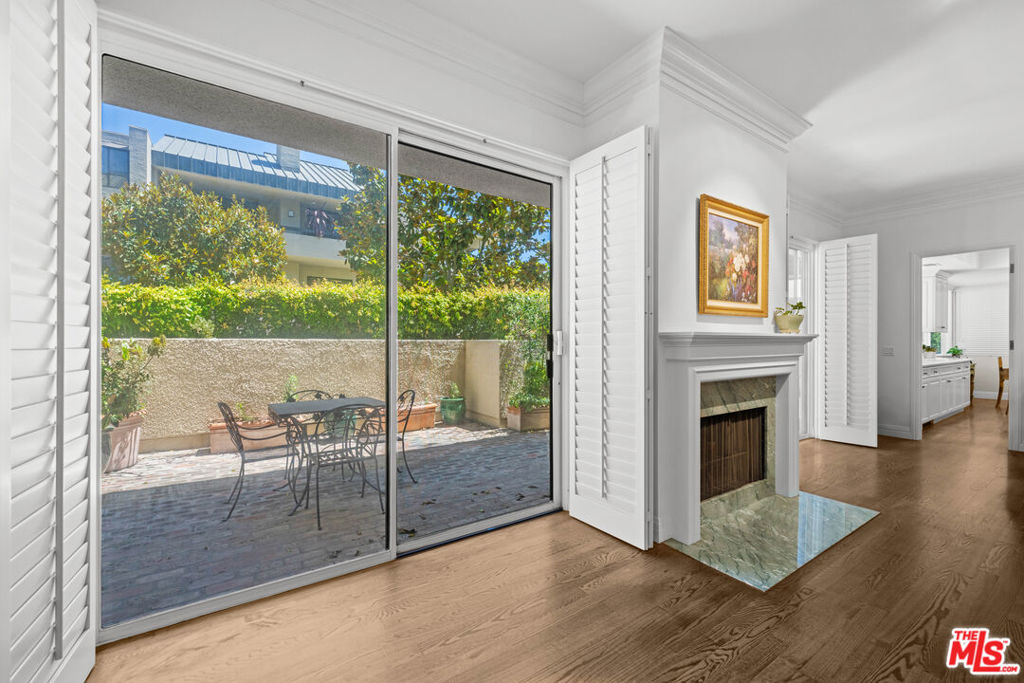 This lovely, quiet, centrally located first-floor single-level condominium was renovated with exquisite designer detail. All rooms overlook landscaped gardens. When you enter this corner unit the Southern exposure fills the rooms with natural light. Hardwood floors along with beautiful crown and base moldings, custom doors and Bouvet hardware continue throughout the entire home. A marble surround and hearth complete the warmth of the living room fireplace. An extra deep patio running the length of the LR & DR can accommodate tables, chairs and chaise lounges. The elegant sunlit kitchen is complete with a center island, custom-built cabinetry, and marble countertops with book marked backsplashes. The cooks kitchen has a Sub-Zero refrigerator/freezer, Kitchen Aid ovens, dishwasher and a built-in microwave over the cooktop. A bright corner breakfast area is open to the kitchen and overlooks landscaped gardens. The high-ceiling primary bedroom suite has ample space for a sitting area and features a private patio with Western exposure. The primary bathroom features rare Italian marble slabs in the shower as well as the tub surround and the dual sink countertop. A light, bright second bedroom features high ceilings and Western exposure. The en suite bathroom has Crema Marfil marble in the shower and countertop. This rare offering is perfect for the discerning buyer. Century Hill offers the most wonderful amenities including 5 pools , a fitness center, large package room, indoor driving tee, on-site management, high-end security and so much more makes this a lovely place to live.