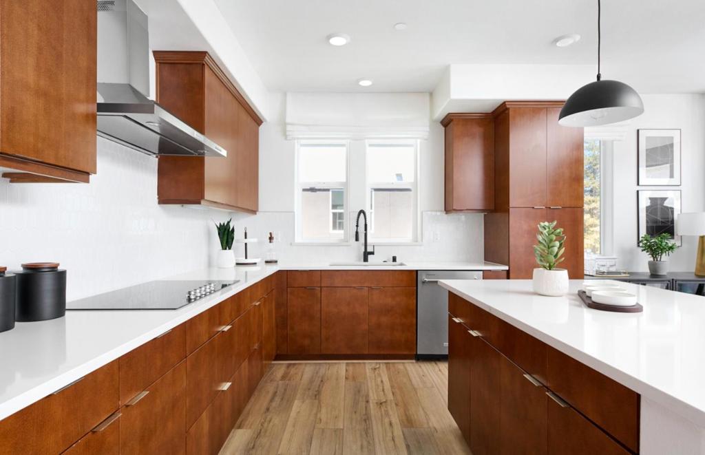 The Plan 3 offers a gourmet kitchen with designer KitchenAid appliances, sleek quartz counters, and LVP in living areas. Enjoy an oversized gathering room, abundant natural light, and the privacy of an end-unit location with a side-by-side garage. Photos are of model home not of actual home.