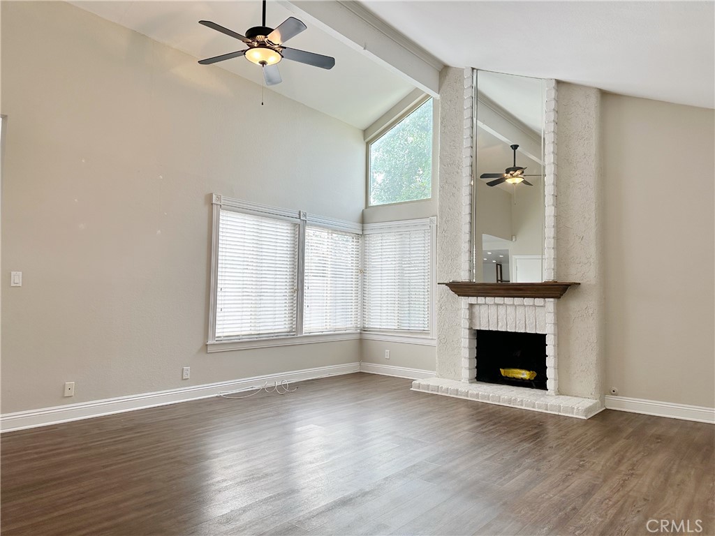 This spacious, single-level attached home is a RARE find in a prime location! You'll love the backyard with a recently done concrete patio, cafe lights, and a manicured lawn - ideal for enjoying summer barbecues, growing your own herbs, and letting your pets roam. A double door entry leads you into the expansive living room with vaulted ceilings, a gas fireplace, and large windows letting in tons of natural light. The kitchen features granite counters, wood-shelving to serve as your pantry or extra kitchen storage, and stainless steel appliances. Save money on appliances as all come included (including fridge and washer/dryer)! Sliding doors off the kitchen/dining area lead to the serene backyard where you can spend warm evenings dining outside. Enjoy luxury vinyl wood-style plank flooring throughout and remodeled showers in both bathrooms. The guest bath was recently remodeled with new tile shower and floors. The primary bedroom ensuite is incredibly spacious with vaulted ceilings, a vanity, walk-in shower, linen cabinets, and a walk-in closet. Sliding doors off both the primary and guest bedrooms lead to a second patio, which provides direct access to the 2-car garage offering added storage. Enjoy the amenities of La Cuesta Tennis Club, including tennis courts, a clubhouse, and parks. Situated within a mile of Five Points with Trader Joes, walking distance to Lambert Park and the greenbelt, and just a 10 minute drive to downtown and the famous beaches of Surf City.