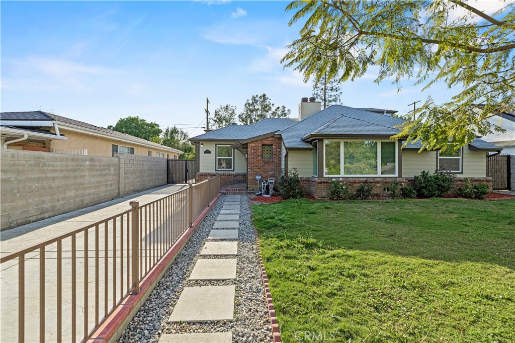 Get ready to be blown away by this incredible find in the heart of Valley Glen! Stunning classic bungalow style home with a private pool and a separate ADU, offering a total of 3 bedrooms, 2.5 bathrooms in the main house, and 2 bedrooms, 2 bathrooms in the ADU. The main house boasts hardwood floors, two indoor fireplaces, beautiful wood beam ceilings, and an updated granite kitchen that opens from a wainscoting formal dining room. The cozy family room, complete with built-in shelving, leads to a bright breakfast room with French windows overlooking the expansive backyard - perfect for entertaining! Featuring upgraded marble bathrooms, inside laundry, and additional rooms upstairs for an office, den, or playroom, this home offers both elegance and versatility. Enjoy the front yard's privacy wall of ten-foot tall privets and the oversized backyard with a covered patio and an Amazing BBQ area.The meticulously crafted ADU is done with quality in mind, offering a space that is both functional and stylish.