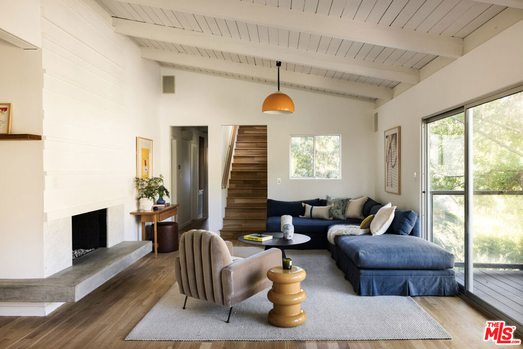 Modern Mid-century tree house in prime Los Feliz Oaks. Tucked away at the top of a long private drive, this 1955 Post & Beam blends classic architecture with thoughtful modern design. Featuring stunning hardwood floors, walls of glass, and tranquil canyon views. Dual-island kitchen with statuary marble, custom walnut cabinetry, and Wolf/Miele appliances. Main level offers two bedrooms and full bath + powder. Upstairs is your private primary suite with sun deck, spa-like bath, and walk-in closet. Bonus room with separate entryideal for studio, office, or storage. Fire pit courtyard and outdoor dining gives you everything you could want. Moments to Franklin Village + Griffith Park and more. Peace and quiet in the city.
