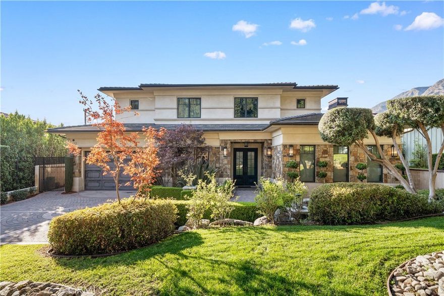 Welcome to this exquisite luxury residence located in Arcadia’s prestigious Highland Oaks neighborhood. Designed by renowned architect Robert Tong and constructed by Bowden Development Inc. this stunning two-story estate exemplifies timeless elegance and exceptional craftsmanship.  The home features 4 full-suite bedrooms and 4.5 bathrooms, all uniquely designed for comfort and luxury. Each additional bedroom is enhanced with its own en-suite bathroom, with the primary suite boasting its own wet bar and private lounge. While this estate was thoughtfully constructed for privacy and convenience, it also offers grandness and elegance. The expansive open-concept living areas flow seamlessly across the main level, creating a welcoming environment for gatherings of all sizes. The chef-inspired kitchen, complete with a separate wok kitchen, is designed with high-end finishes and appliances to meet the needs of culinary enthusiasts and entertainers alike.  The home is equipped with an advanced iPad-integrated automation system, providing intuitive control over all major functions of this remarkable estate.  The outdoor living area is equally impressive, offering a custom grilling station, built-in media center, and covered patio designed for year-round enjoyment.  Nestled along a serene tree-lined at the foothills of the San Gabriel Mountains, this property provides an exceptional blend of natural beauty and designed for modern living.  Located within the award-winning Highland Oaks school district and the natural beauty of one of Arcadia's most sought-after communities. This Arcadia residence represents a rare opportunity to experience luxury living in an area known for its tranquility, prominent district, and enduring appeal.