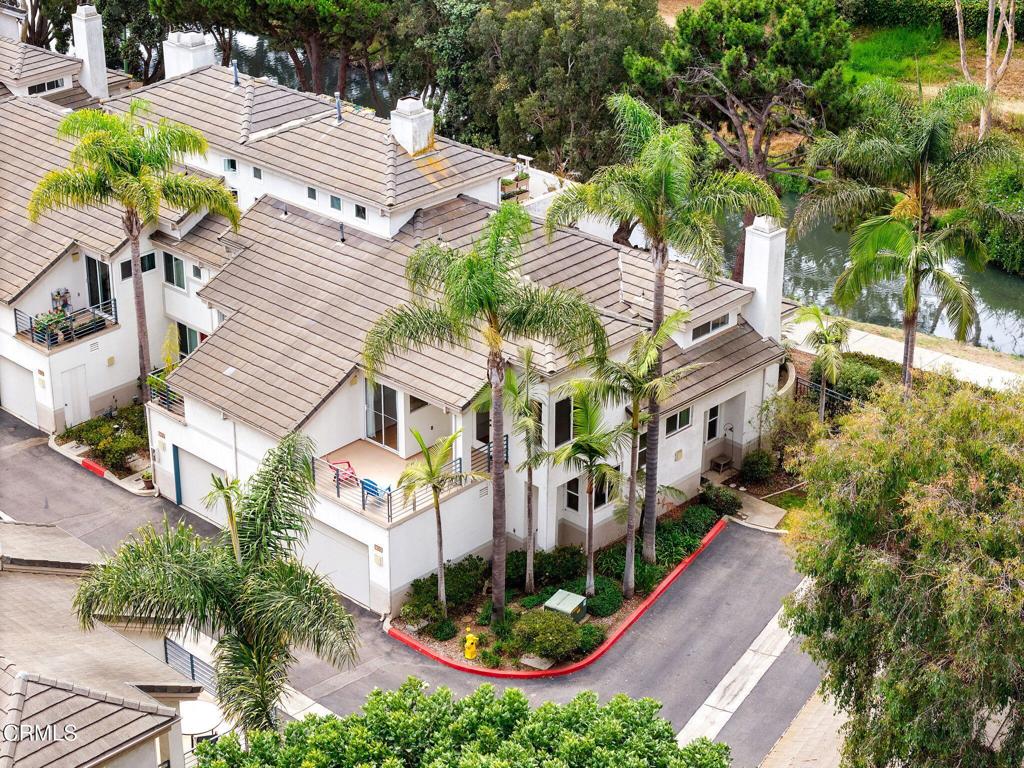 Coastal End-Unit Townhome with Park & Water Views - Steps to the BeachWelcome to your coastal dream home! This immaculate, beautifully maintained end-unit gated townhome is perfectly situated to capture serene views over a peaceful park and stream, all just a short stroll from the beach.Nestled in the charming seaside town of Port Hueneme, ideally located between Malibu and Santa Barbara, this home offers a relaxed beach lifestyle with easy access to the historic pier, tennis courts, vibrant parks, and oceanfront pathways.Inside, the spacious layout features three bedrooms--each with access to the front or back deck--plus two oversized walk-in closets. The thoughtful floor plan includes two full bathrooms upstairs and a guest powder room downstairs, along with a formal dining room, open kitchen with custom cabinetry, and a versatile den ideal for a home office or entertaining space.Additional highlights include:Private location at the back of the community for maximum privacy and tranquilityTwo-car attached garageGated, well-kept community with lush landscapingMultiple decks for enjoying ocean breezes and sunset viewsWhether as a full-time residence or a weekend retreat, this move-in-ready home delivers the best of coastal living--walk to the beach, then come home to park views, ocean breezes, and a serene atmosphere.