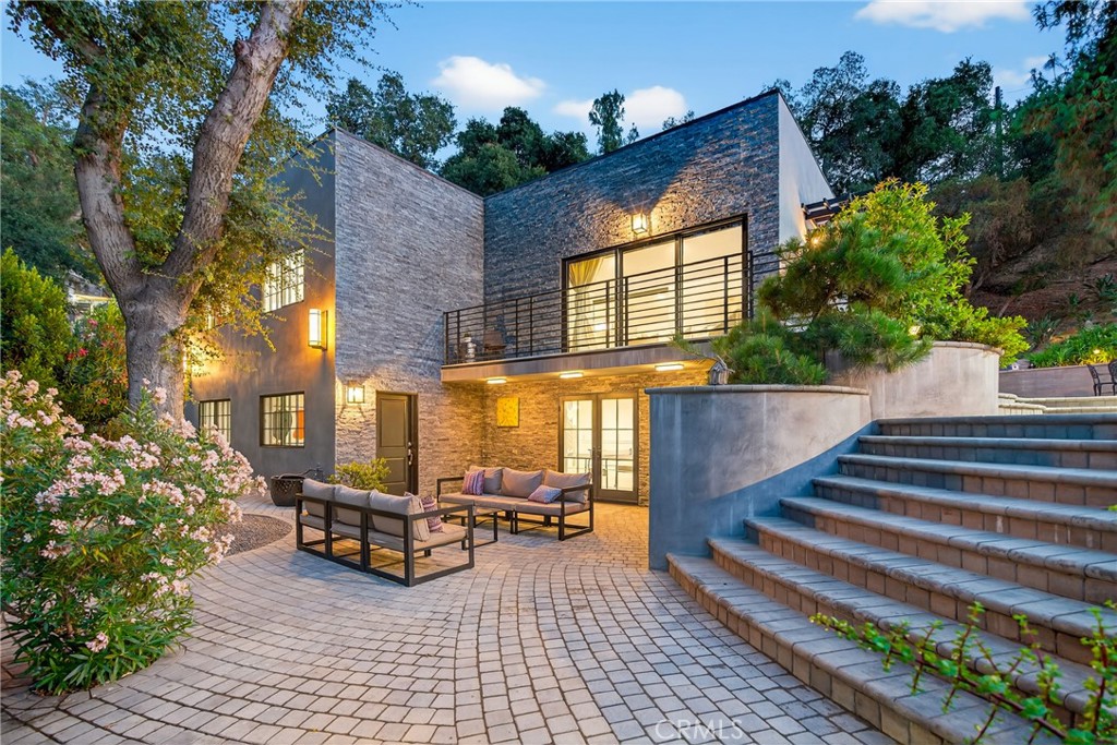 Set on 4.4 acres of beautifully landscaped grounds, this remarkable multi-parcel estate offers three remodeled residences included together for one price—a rare opportunity in Los Angeles County. Blending modern luxury, artistic design, and serene outdoor living, the property is surrounded by lush gardens, mature oaks and cherry blossoms, and sweeping mountain views, delivering an unmatched sense of privacy and tranquility. At the heart of the estate is a Japanese garden by renowned designer Tomoyuki Nakamura, complete with a 12-foot Torii gate, a peaceful picnic area, and a rare imported glass greenhouse. Custom artistic touches and faux bois by Terence Eagon, stonework hardscaping, and a fully irrigated hillside enhance its distinctive charm. The main residence offers 5 bedrooms and 4 bathrooms, thoughtfully renovated in 2023 with porcelain tile floors, Shoji screen closets, a stone fireplace, and a chef’s kitchen with stainless steel appliances and quartz countertops. Fleetwood sliding doors open to garden-view balconies, creating a seamless indoor-outdoor flow. The second home features 1 bedroom and 2 bathrooms, while the third offers 3 bedrooms and 2 bathrooms—both with ample space and ideal for guests, extended family, or income opportunities. Perfectly located next to McGroarty Park with two playgrounds and tennis courts, as well as the McGroarty Arts Center, which hosts vibrant community events and creative classes, and only minutes from Angeles National Golf Club—one of the premier courses in Los Angeles County—this one-of-a-kind property delivers exceptional comfort, artistry, and natural beauty, all in a private, tranquil setting.