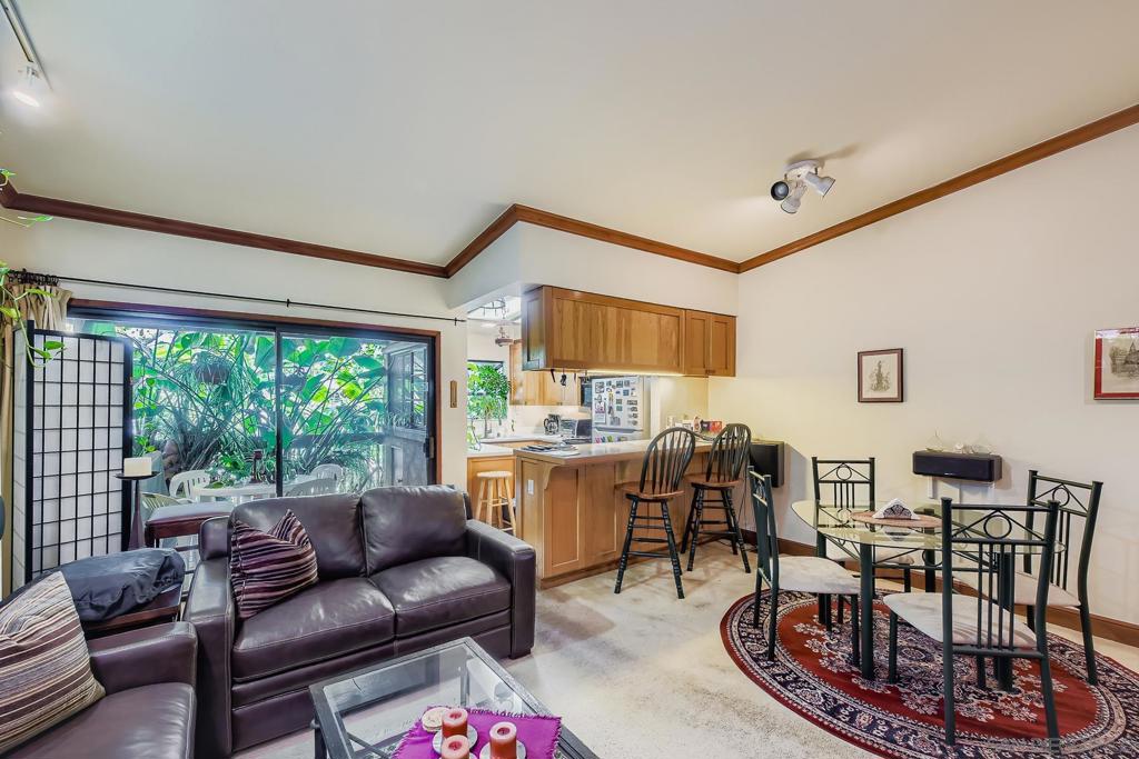 Experience the magic of La Jolla living in this rare top-floor, one-level residence within the sophisticated Boardwalk complex. Located just over the hill from world-famous La Jolla beaches, this home offers the close residential proximity to the exclusive UC San Diego campus. Step into a lush paradise with high vaulted ceilings and a thoughtful open floor plan that creates a sense of airy spaciousness. A pass-through breeze from the north and south keeps the home feeling fresh and cool. The well-cared-for interior features rich wood cabinetry, handsome crown molding, and a charming rustic brick fireplace. The living area is highlighted by track lighting and ample shelving, perfect for displaying your book collection or art pieces. This secluded retreat is also centrally located, placing you directly across the street from a shopping center with Whole Foods and Nordstrom Rack. An adjacent mall with Ralph's and an AMC theater is also just a short walk away. Additional amenities include private interior laundry, a private balcony, and secure underground parking. Complex amenities include pool and tennis courts. This is an incredible opportunity to live in an exclusive location with unparalleled convenience.