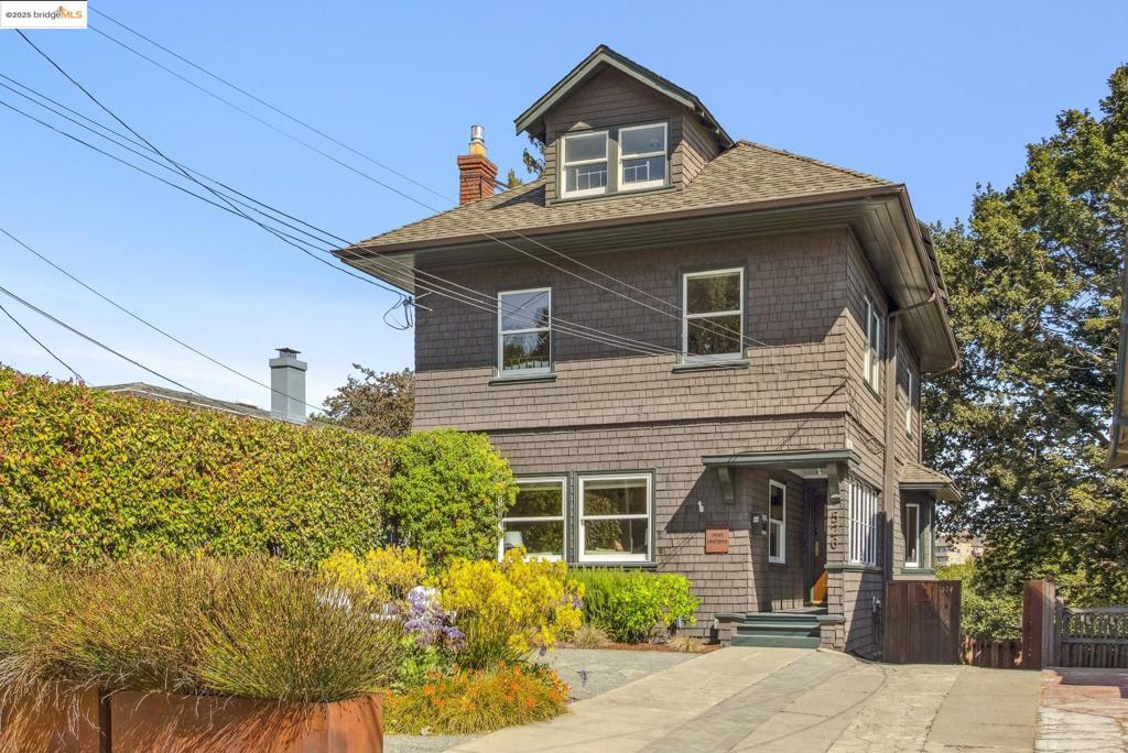 One-of-a-kind 1910 brown shingle with full secondary unit downstairs. Beautifully maintained and updated, with numerous energy efficiencies and upgrades. Rich wood detail throughout. Gas fireplace in living room. Large formal dining room with window bench opens out to lovely deck. Eat-in kitchen with breakfast bar, adjacent pantry and half-bath. Upstairs are primary suite with recently remodeled bathroom and stirring views of Crocker hills; plus two additional bedrooms and bathroom. A roomy finished attic has a big flex space for media or work, as well as a fourth bedroom. "Mini-splits" (heat pump + AC) in most rooms for individualized climate control. Below the main level and with its own gated patio is a full secondary unit with kitchen, bathroom, laundry and AC. The lush terraced backyard boasts an outdoor kitchen, patio area with fire pit, lawn, decks, and various arrangements for play or for a quiet evening under the stars. Car charger in driveway; solar panels. Blocks to Grand Ave or Piedmont Ave shops and restaurants. OPEN MONDAY, SEPT 15 FROM 10:00AM-1:00PM.