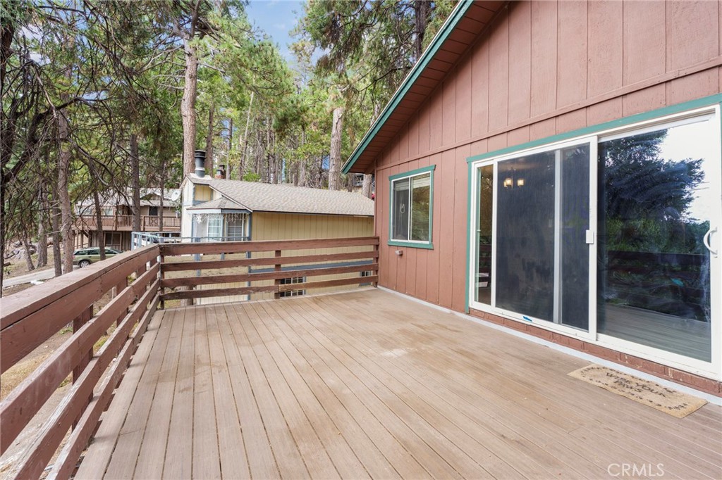 This 3-bedroom, 1.5-bath mountain cabin offers 1,280 sq ft of living space on a generous 6,600 sq ft lot in the desirable Upper Rowco neighborhood. With a partially completed remodel already underway, this home is full of potential for the buyer ready to add the finishing touches. The main level features a cozy living room with a wood-burning fireplace, a full bathroom, and one bedroom—perfect for easy single-level living. The kitchen boasts newer cabinets, a newer microwave and dishwasher, and unique quarter countertops. Step out onto the spacious back deck with newer Trex decking—ideal for relaxing or entertaining among the trees. Downstairs, you'll find two additional bedrooms, a half bath, a laundry area, and ample storage. The home includes a mudroom entry, off-street parking, central heat powered by a 2-year-old furnace, and a 4-year-old water heater. Flooring throughout the home was updated just 4 years ago. Whether you're looking for a full-time residence, weekend getaway, or investment opportunity, this cabin is a solid foundation for your vision. Come finish the remodel and make this mountain hideaway your own!