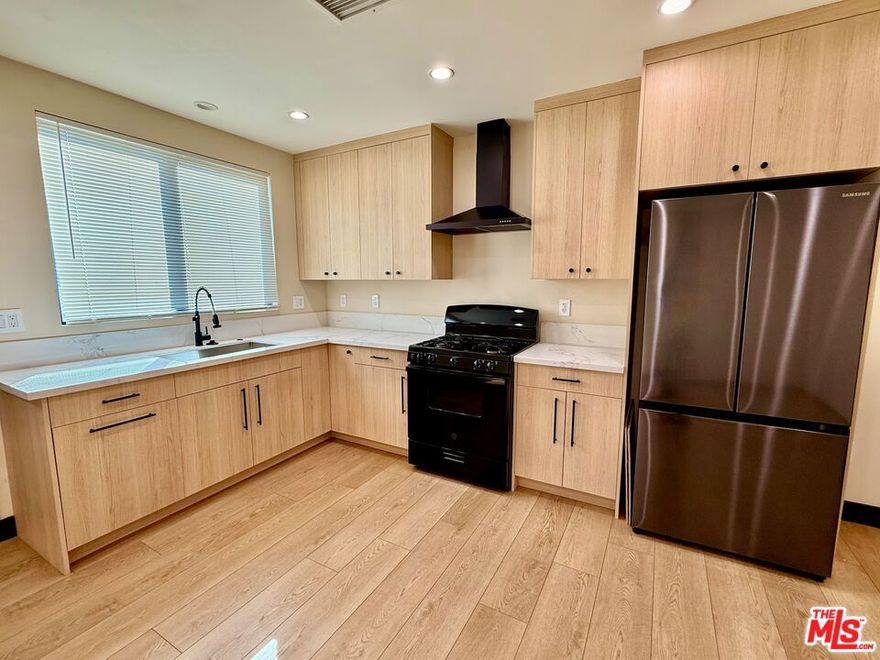 Welcome to this beautifully remodeled ADU back house in the tranquil community of Reseda. This inviting one-bedroom, one-bathroom home features brand-new appliances including a refrigerator and gas range paired with ample countertop space that makes meal prep effortless. Hardwood floors flow throughout the home, complemented by central AC/heat for year-round comfort. The bathroom offers a touch of luxury with rainforest shower heads, and the convenience of an in-unit stackable washer and dryer adds to the home's modern appeal. The bedroom provides a cozy retreat with plenty of space for your furnishings and personal belongings. For added convenience, the unit includes one gated parking spot located right next to the home, as well as a small private outdoor area off the bedroom. With its prime location, you'll enjoy easy access to major highways and public transportation, making commuting simple and stress-free. Don't miss the chance to make this thoughtfully upgraded apartment your new home!