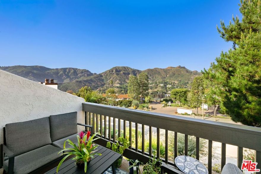 Stunning Mountain Views & Resort-Style Living in the Palisades Highlands! This coveted end-unit Michael Lane Villa townhome offers nearly 2,500 sq ft of refined living across three thoughtfully designed levels. Framed by dramatic vistas of the Santa Monica Mountains, the home seamlessly blends tranquility, elegance, and versatile functionality. A welcoming front patio and dedicated foyer introduce the residence and open to a generous multi-purpose flex space - perfect as a den, library, sitting room, creative studio, gym, or guest suite - complete with a wet bar and a full en-suite bath. Enjoy access to the expansive private patio overlooking sweeping canyon and mountain scenery, creating an exceptional indoor outdoor flow ideal for relaxation or entertaining. The mid-level conveniently offers direct access from the private two-car garage and features an airy formal living room with soaring ceilings, a fireplace, and a private balcony capturing stunning mountain and canyon views. The adjacent formal dining room with views is perfect for large gatherings and connects effortlessly to the spacious kitchen, with ample cabinetry and storage, granite countertops, and a charming breakfast area. A powder bath completes this level. Continue upstairs to the grand primary suite - a serene retreat with its own sitting area, cozy fireplace, private view balcony, expansive walk-in closet with two additional closets, and a luxurious en-suite bath designed for comfort and unwinding. A spacious second-bedroom suite offers excellent closet space, a beautifully updated bathroom and provides flexibility for guests or family. Additional highlights include high ceilings, multiple balconies, and the extra natural light and privacy afforded by an end-unit setting. Residents enjoy access to resort-style community amenities, including a beautiful pool/spa, sauna, fitness center, 2 guest parking spaces conveniently located behind this home's garage, and an HOA that includes water and ACS Palisades Highlands security. This exceptional residence delivers a rare combination of stunning views, surrounding natural beauty, and spacious sophisticated living in one of the most picturesque enclaves of the Palisades Highlands.
