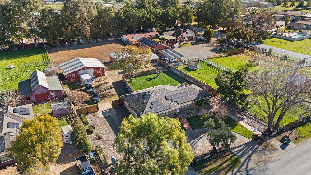 THIS HOMES OFFERS SO MANY FEATURES - YOU'LL LOVE IT..! New "Great-Room" Kitchen. 7.5k 'owned' Tesla Solar. Giant 1,200 sq ft 4-car Garage/Shop w/professional grade auto lift. Large, separate Barn with room for trucks; boat; ATV's or hay to feed the horses you can keep in the metal, 2-Stall Barn; and fenced arena. Complete remodel is well planned with extra features and quality of workmanship throughout. You will love the effort that has been given to improve and include the kind of things that make life easier, efficient and more care-free. Many of these features are often only added, or even thought of "after" they need to be fixed. It's all been done. So, if you want to relax when you come home instead of working on all those little "fix it" things, this home is for you. Or if would rather devote your "fix-it" time and effort to that great collector car currently in a tiny garage, then look no further. If you want to have room to expand and be creative, this home is for you. If you want room for animals; a garden; or a place to enjoy your hobbies, this home is for you. Kids will love the lush green grass in the large, separately fenced back yard. Parents will enjoy the front, sliding gate security and separate back gate. Come relax and enjoy the country life.