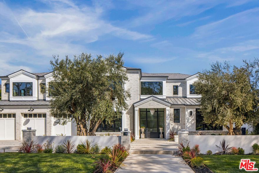 1220 Corsica Drive is a striking new custom estate nestled in the coveted Lower Riviera. Designed by renowned architect Ken Ungar with interiors by Matthew Brinkley of Studio Brinkley, this 10,293-square-foot contemporary residence spans three levels, balancing bold scale with refined comfort. A dramatic double-height foyer, opens to an expansive living and dining areas adorned with custom oak paneling, fluted textures, and a curated mix of luxurious finishes. The chef's kitchen is a centerpiece of the home, featuring sculptural marble surfaces, bespoke cabinetry, a walk-in pantry, and a separate staff kitchen perfect for seamless entertaining. The main floor also includes a sophisticated home office, wine bar, oversized laundry with dual washers and dryers, and a guest suite with private access to the rear grounds. Upstairs, the primary suite offers a serene retreat with a private terrace, spa-like bath with soaking tub and oversized marble shower, dual walk-in closets, and a peaceful sitting area. Additional bedrooms are generously sized, each with an en-suite bath and abundant natural light. The lower level is built for leisure and entertainment: a state-of-the-art theater, full bar and lounge, wine cellar with tasting room, expansive fitness center, and a wellness suite with sauna, steam shower, and a private bedroom. An elevator connects all three levels with ease. The resort-style backyard features a pool and spa, a cascading water feature, multiple lounge areas, a fire pit, an outdoor kitchen, and a pergola for al fresco dining, all framed by mature olive trees and privacy hedges. Thoughtful lighting creates a warm and inviting ambiance after dark. This home is equipped with integrated smart home technology, solar power, and top-tier systems, this home embodies modern luxury, architectural excellence, and resort-caliber amenities in one of the Westside's most prestigious​​‌​​​​‌​​‌‌​​‌​​​‌‌​​​‌​​‌‌​​​‌​‌​​​‌‌​ neighborhoods.