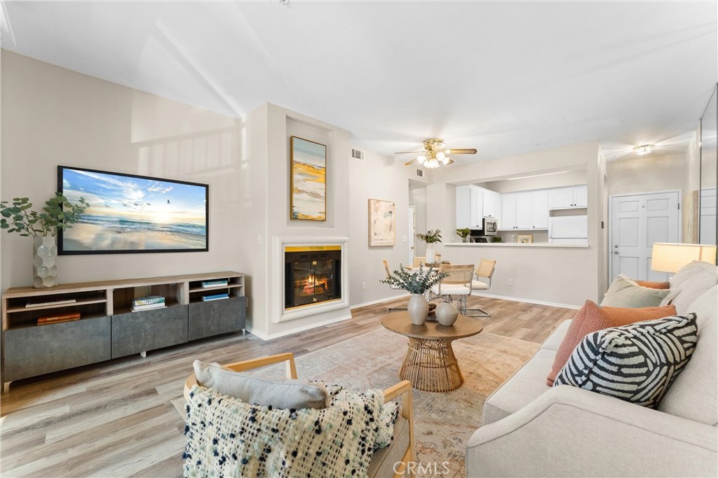 Beachside condo for the 2028 Olympics, Corner unit 2 bed, 2 bath, 2 parking spaces, private balcony, in-unit laundry, and walkable access to downtown Long Beach dining, shopping, and entertainment. This spacious two bedroom, two bathroom home features an open floor plan with durable vinyl flooring, a striking mirrored wall that enhances the sense of space and natural light, and a cozy fireplace that creates a warm and inviting living area. The living room flows seamlessly to a private balcony, ideal for enjoying fresh air and outdoor relaxation. The kitchen is equipped with white cabinetry, tiled counters, a stainless steel microwave, gas stove, and a breakfast bar that connects to the dining and living space, making it perfect for entertaining. Both bedrooms are generously sized with large mirrored closets, while the primary suite includes its own private bath. Additional highlights include the convenience of in-unit laundry with a stacked washer and dryer, and two assigned parking spaces (#34 and #35) in the secured community garage. Located just blocks from the ocean, the Long Beach Aquarium, Convention Center, The Promenade, new City Hall, and the new library, this home is surrounded by vibrant restaurants, shopping, and coastal attractions. With gated entry, proximity to Metro access, and walkability to everything Downtown Long Beach has to offer, this condo is as convenient as it is desirable. Just in time for the 2028 Olympics, it’s the perfect place to call home or an incredible opportunity to rent out during the games.