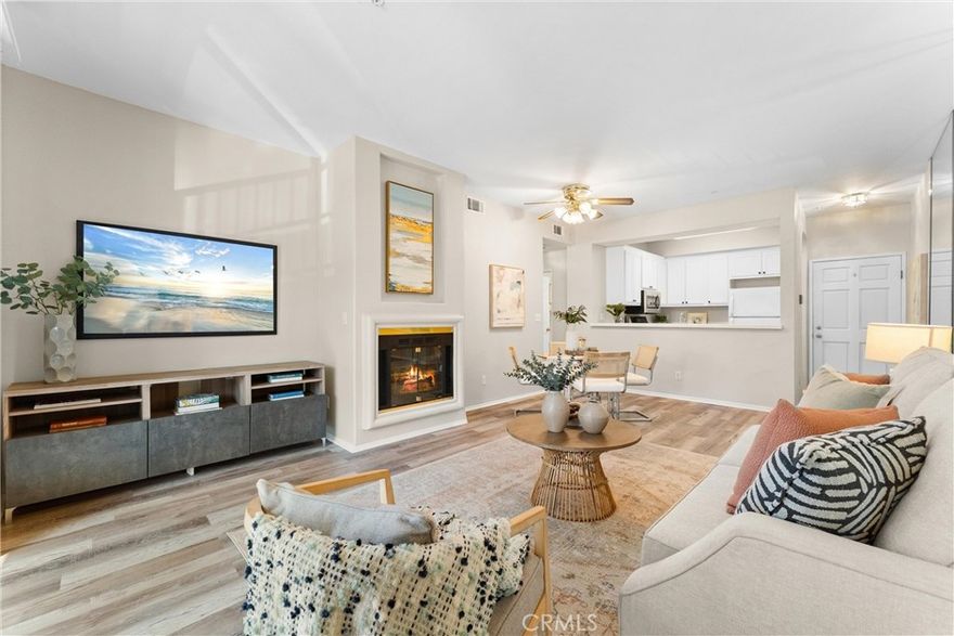 Beachside condo for the 2028 Olympics, Corner unit 2 bed, 2 bath, 2 parking spaces, private balcony, in-unit laundry, and walkable access to downtown Long Beach dining, shopping, and entertainment. This spacious two bedroom, two bathroom home features an open floor plan with durable vinyl flooring, a striking mirrored wall that enhances the sense of space and natural light, and a cozy fireplace that creates a warm and inviting living area. The living room flows seamlessly to a private balcony, ideal for enjoying fresh air and outdoor relaxation. The kitchen is equipped with white cabinetry, tiled counters, a stainless steel microwave, gas stove, and a breakfast bar that connects to the dining and living space, making it perfect for entertaining. Both bedrooms are generously sized with large mirrored closets, while the primary suite includes its own private bath. Additional highlights include the convenience of in-unit laundry with a stacked washer and dryer, and two assigned parking spaces (#34 and #35) in the secured community garage. Located just blocks from the ocean, the Long Beach Aquarium, Convention Center, The Promenade, new City Hall, and the new library, this home is surrounded by vibrant restaurants, shopping, and coastal attractions. With gated entry, proximity to Metro access, and walkability to everything Downtown Long Beach has to offer, this condo is as convenient as it is desirable. Just in time for the 2028 Olympics, it’s the perfect place to call home or an incredible opportunity to rent out during the games.