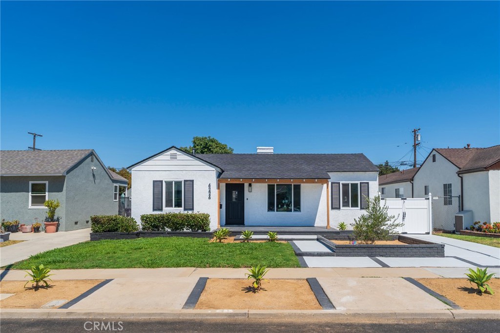 Welcome to this beautifully renovated single-story home, where modern design meets luxurious comfort. Located in a highly desirable neighborhood in Long Beach, CA. This stunning property boasts a spacious open floor plan with 4 generously sized bedrooms and various premium features that elevate your living experience. Two full bathrooms have been tastefully renovated with modern mid-century touches. Step inside through a beautiful wood door and be greeted by the inviting ambiance, enhanced by recessed lighting, new white interior/exterior paint, all new windows, and premium laminate wood flooring throughout the home. The heart of this home is the chef-inspired kitchen, complete with gleaming quartz countertops, all-new stainless steel appliances, custom shaker-style slow-close cabinetry, and a custom peninsula with a waterfall finish perfect for both cooking and entertaining. There is a warm and inviting family room and a separate formal living room, which features a beautiful fireplace, providing a perfect setting for relaxing. Enjoy the private and cozy backyard to host all of your special gatherings. The 2-car detached garage has been finished with drywall and new paint that can be used for an additional entertaining/hobby area. With its thoughtful design, premium finishes, and a fantastic layout, this home is the perfect blend of modern living and comfort. Don't miss this chance to make this property your DREAM HOME!