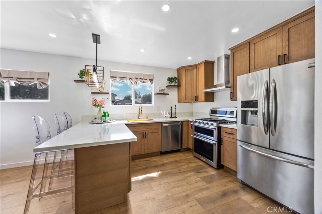 Beautifully upgraded single-family home in Downey! This move-in ready property showcases modern updates throughout, including a new roof, new floors, new kitchen, new bathroom, new doors, new windows, and a new electrical panel. The exterior shines with new siding, a landscaped walkway, and decorative brick accents that complement the freshly landscaped yard. Enjoy lush new grass, privacy trees, and fruit trees (lemon, avocado, and mango) – all enclosed by a white vinyl fence for added security and curb appeal. Inside, the home features ceiling fans in the bedrooms, a modern kitchen lighting fixture, and a mini-split unit in the living room for year-round comfort. Ample parking is available in the back. Conveniently located near popular eateries, schools, shopping, and transportation.