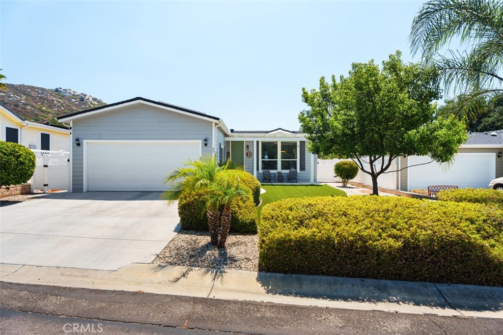 Gorgeous 2018 Manufactured home with attached 2 car garage in the desirable all age community of Oak Tree Ranch!
Beautiful curb appeal includes Artificial turf and other low maintenance plantings. Prime location across from the pool, club house and extra guest parking!
This home has 1600 sqft, 3 bedroom, 2 bath, open floorplan! Front living room currently being used as a home office and exersize space. A dining room area adjacent to the kitchen. The family room is to the back of the house with direct access to the back yard and patio. This home features PAID FOR SOLAR, 4KW , Tesla Panels installed in 2021, CROWN MOLDING throughout. NO CARPET! Luxury wood plank vinyl flooring! Carpet was removed from bedrooms in 2022 and replaced with upgraded Engineered hardwood flooring. Seller has spent $50K in 2025 on the fully REMODELED BATHROOMS with beautiful tiled step in showers! Dual sink vanity in the primary suite with WALK-IN CLOSET! The upgraded Kitchen is equiped with stainless steal farm house sink, gas stove , plenty of storage and counter space, Granite counters, white Mission style cabinetry, stacked stone backsplash, side by side refrigerator, microwave ,dish washer and pendulum lighting over the breakfast bar. Other features include recessed lighting, coved ceiling in living room, upgraded 5"baseboards, ceiling fans in all bedrooms, living room, and family room, arched stacked stone FIREPLACE in Family room with raised stone hearth and wood mantle. Large indoor laundry room gives access to the garage. The backyard is fully fenced and privite, backing to the creak bed (creekbed is maintained by the park management)
Oak Tree Ranch is a land lease community for all ages. Pets are welcome with some restrictions(no weight or breed limit). Monthly land lease is approx $1411 and subject to yearly increase. You really must visit this community to appreciate all it has to offer and the lovely standard of living it provides it's residents. Oak Tree Ranch is truly a wonderful place to call Home. The community offers many amenities including a pool, play ground, car wash area, community garden , dog park and grassy picnic area, lovely remodeled club house with library and full kitchen. Hughes internet,Direct TV . You'll love this lifestyle!!