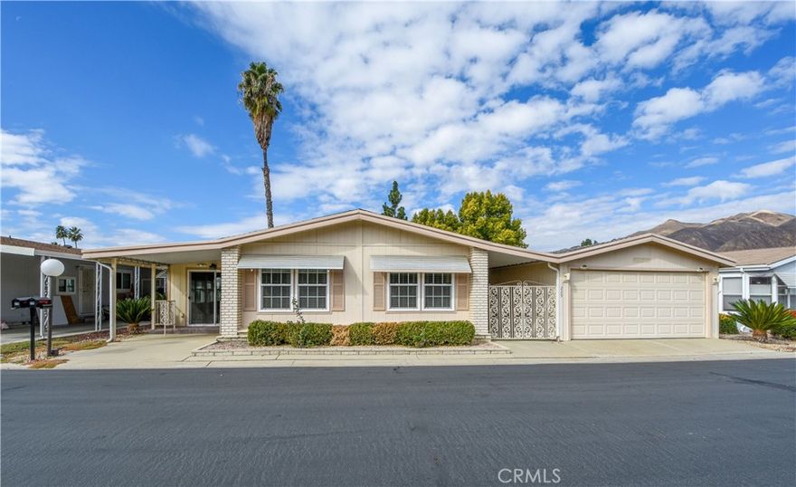 Newly renovated 2bd/2 bath with bar, bonus room, office and detached 2 car garage! 
Open floor plan with soaring vaulted ceilings in living room. Beautiful natural light from skylights reflect on the newly white painted walls and ceilings. New roof installed in October and brand new carpet installed in November. Kitchen updates include LED dimmable lighting, new garbage disposal and painted cabinets. The kitchen's diner style booth adds unique charm. HVAC ducts professionally cleaned and HVAC/Electric systems inspected and in proper working condition. New smoke and carbon monoxide detectors in house. Bathroom updates included new shower fixtures, paint and flooring. Enclosed bonus room off the living room and an office full of cabinets, a built in desk and coat closet provide extra space for storage and creative pursuits. Wood paneled bar with sink and shelving offers a cool space for cocktail parties and entertaining guests. Detached garage provides more storage opportunities and protection for your vehicle. Spacious yard with awning, mountain views and prolific fruit trees offer a private outdoor sanctuary. Located in Soboba Springs Mobile Estates at the base of the San Jacinto Mountains; this 55 plus community is known for its tranquil lake and expansive greenbelts, and offers a wealth of amenities for its residents: Putting and chipping greens, a billiards room, craft room, pool, jacuzzi, sauna, library and game room. Turnkey with impressive upgrades, this may be the home you've been looking for.