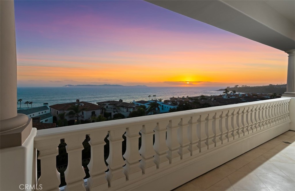 Experience unparalleled coastal luxury at this custom estate in the exclusive guard-gated community of Ritz Cove. Perched on an elevated half-acre bluff at the end of a cul-de-sac, this corner residence boasts no neighbor on the south side and offering panoramic vistas of Catalina Island, Salt Creek Beach, and the lush adjacent parkland.
Designed for both grand entertaining and intimate relaxation, the home features five expansive en-suite bedrooms. Notably, two are primary level suites with sweeping ocean views through exceptional picture windows, and each adorned with a fireplace and private terrace—providing serene retreats that capture the essence of seaside living. All bedrooms are generously sized, with four featuring their own fireplaces and terraces, enhancing the indoor-outdoor lifestyle.
The recently upgraded chef’s kitchen is a culinary masterpiece, equipped with Taj Mahal quartzite countertops, custom cabinetry, and top-of-the-line Sub-Zero and Wolf appliances. Floor-to-ceiling windows throughout the home flood the interiors with natural light and frame the breathtaking coastal scenery.
Additional highlights include a grand two-story foyer, a wood-paneled study, a formal living and dining room, and an upstairs lounge with a fully equipped bar. The outdoor oasis is complete with a resort-style pool and spa, outdoor fire features, and a built-in cook center—perfect for entertaining against the backdrop of the Pacific Ocean.
Situated between the renowned Ritz-Carlton and Waldorf Astoria resorts, and just moments from Monarch Beach Golf Links, this estate offers direct gated access to the beach trail, placing the sand and surf just steps from your backyard.