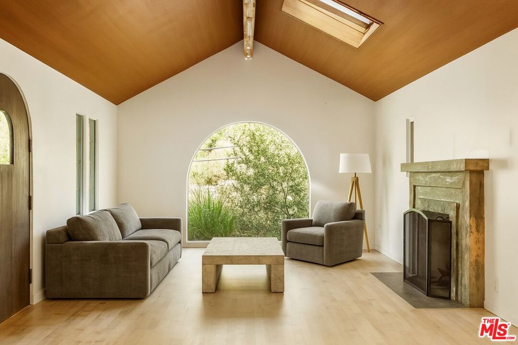 Tucked into the lush, coveted Santa Monica Canyon, 407 W Rustic Road is a stunning modern retreat offering the perfect blend of design, privacy, and indoor-outdoor living. This 3-bedroom + office, 2.5-bath home is wrapped in curated outdoor spaces, including a rooftop deck with treetop views, a private front patio with built-in firepit, and a large backyard that allows for seamless entertaining. Inside, skylights and large windows spill natural light into the open concept living spaces. The gourmet kitchen with Sub Zero and Viking appliances connects effortlessly to the formal dining area with large French doors that open up to the private yard with mature landscaping. Upstairs, the primary suite feels like a sanctuary, with a spa-like bath and ample storage. All this, just minutes from Canyon Elementary, the beach, and the the world class dining and shopping of Montana Ave and The Promenade.