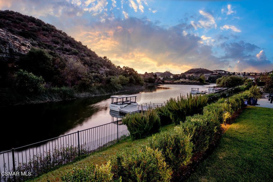 Welcome to an exquisite Hampton-style estate, an embodiment of opulence and sophistication, privately nestled in a tranquil cul-de-sac within the prestigious gates of Sherwood Country Club. This magnificent residence offers unrivaled Southern California luxury, with direct access to the crystal-clear waters of Lake Sherwood, presenting an exceptional fusion of elegance and serene living.Spanning an impressive 6,459 square feet, this two-story marvel features 5 generously proportioned bedrooms, 5 sumptuous bathrooms, and an additional powder room for guests. A refined den/office and a formal dining room seamlessly transition into the gourmet kitchen, where high-end finishes and top-of-the-line appliances promise culinary excellence and grand entertaining.The expansive Great Room exemplifies the essence of indoor-outdoor living, effortlessly extending to a grand patio designed for alfresco dining and relaxation under the stars. State-of-the-art home automation, including a sophisticated Lutron lighting system and a cutting-edge solar power system, ensures both luxury and energy efficiency. The estate also boasts its own private dock, providing seamless access to Lake Sherwood's serene waters.Encircled by the awe-inspiring Santa Monica Mountains, the property offers breathtaking panoramic views that foster a sense of tranquility and seclusion. Embrace the finest aspects of outdoor living amidst unparalleled Southern California weather. Just a short stroll away, you can revel in the luxurious amenities of the Sherwood Lake Club, including the prestigious Jack Nicklaus-designed Par-3 Signature Golf Course.This estate is more than just a residence; it is a statement of a refined lifestyle. Every detail, from modern conveniences to the majestic natural surroundings, has been meticulously crafted to provide an extraordinary living experience that is truly unparalleled.This Estate Comes with an Unparalleled Lifestyle.This remarkable estate offers more than just a home--it comes with a lifestyle. The seller is including a Lake Sherwood Club Membership, providing access to world-class amenities and leisure opportunities.