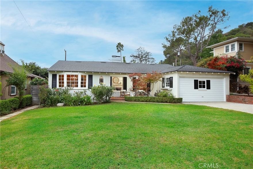 Santa Barbara is a unique avenue of annual block parties and kids actually playing on their front lawns in the shade of mature trees.  These Owners have loved living here for over 40 years.  In that time that have preserved the original character while transforming it to this elegant one-story estate of almost 3,000 sf.  
The formal entry opens to a beautiful formal living room with rich wood flooring, original double hung windows, and a warm fireplace.  The dining room seats a rather large party for formal entertaining.  The kitchen has been tastefully remodeled and expanded with more wood flooring, custom cabinetry, dark quarts counters, high end appliances and a large breakfast room. Of course, this culinary hub of the house opens to the family room with its own fireplace, custom built-ins, and glass doors that open to the rear grounds.  
The primary suite is its own wing with a huge bedroom with an antique marble fireplace mantel, a true walk-in closet, and a glorious bath with dual sinks, separate stall shower, and a soaking tub.  The west wing has two more large bedrooms, two gorgeous remodeled baths, and perhaps the best home office I have ever seen with a high ceiling, custom cabinets, and a wall of glass that opens out to the private paradise yard with a spectacular pool and spa. This room was also designed to be a fourth bedroom with its own ingress.   This is a rare home that offers more features than I can list, but just a few include a newer roof with solar panels, updated copper plumbing, updated electrical panel, central air and heating, and a two-car attached garage.