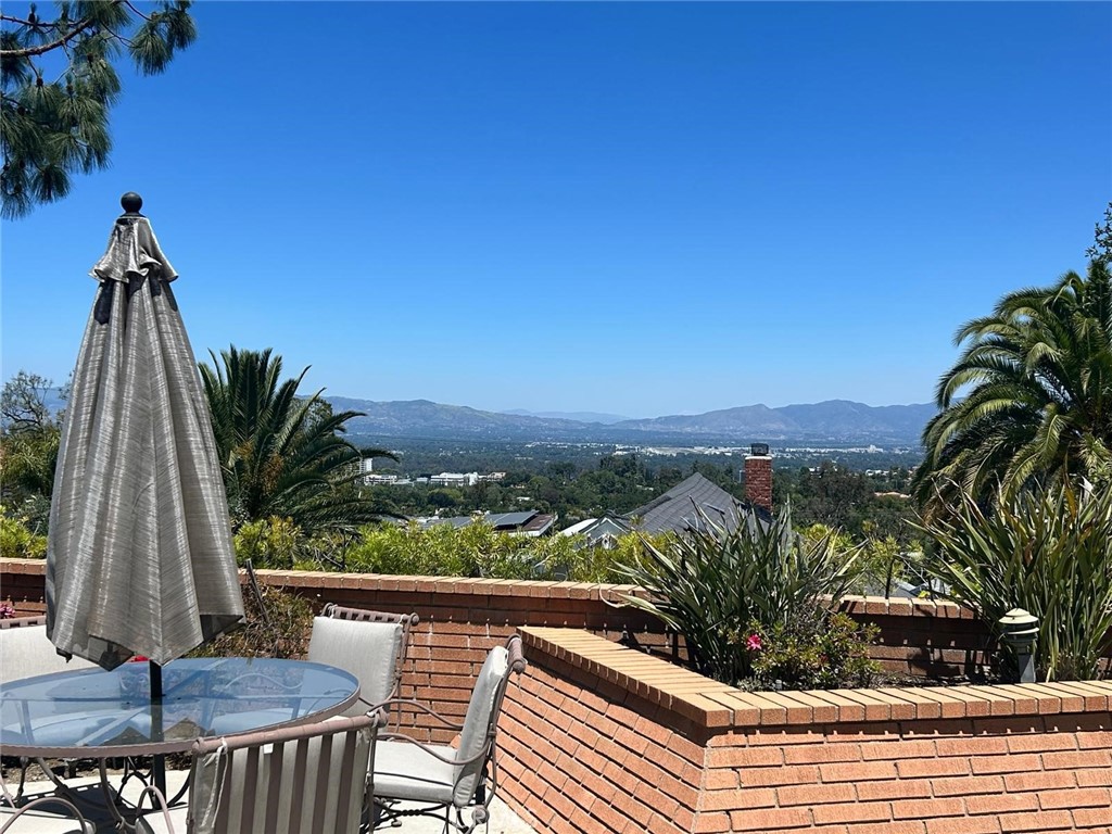 SOUTH OF VENTURA BLVD | VIEWS | LANAI SCHOOL DISTRICT | RECENTLY REMODELED
WELCOME TO YOUR NEW DREAM HOME. Upon arrival you will be greeted by a beautiful private courtyard and pathway that leads to a bronzed double-door entrance and grand foyer which opens to an expansive, light and bright, single level open floor plan. Inside boasts custom windows, recessed lights, large formal dining room with custom ceilings, and eat-in kitchen that opens to family room. This home features brand new flooring throughout, brand new soft paint selection to compliment the original wood finishes. From the kitchen featuring newer appliances with an oversized island perfect for family gatherings to an open and adjacent living/family area with 180 degree views of the San Fernando Valley. The primary suite features expansive views, spacious walk in and accessory closets, and a patio with direct access to backyard. A few steps away is the expansive primary bath featuring a dual oversized vanity, spa-style shower, and direct patio access. The secondary bedrooms feature abundant natural lighting, ample closet space w/ organizers, district views, and much much more. Within close proximity is a spacious shared hall bath featuring an oversized vanity/mirror area, tub, and built in shower. This quiet oasis of a home is fitted with an attached laundry room w/ modern washer/dryer, generous storage and direct access to a large two-car garage (storage shelving included), and full bath for guest parallel to kitchen area. Making our way outside to your entertainers' dream backyard, 180-degree views with compliments of tree-lining and greenery, brick-lined spa, and plenty of square footage for family gatherings, special occasions, and much much more. SCHEDULE A TOUR TODAY, THIS HOME WILL NOT LAST!