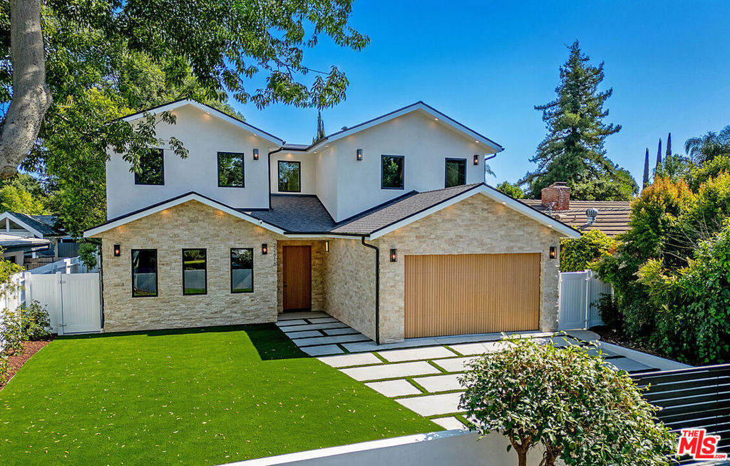 Privately Gated Estate in the Heart of Woodland Hills. Completed in June 2025, this property is a rare blend of luxury, privacy---crafted with designer finishes, and sleek, modern materials throughout both the main residence and the legally permitted ADU (with its own address). Step inside the stunning main house to discover 9'10" high ceilings, surround sound speakers, designer lighting, solid oak doors, Roman stone accents and wooden flooring. The chef's kitchen features top-of-the-line Thermador appliances, porcelain countertops, wine closet, immense pantry and other thoughtful storage solutions. With an open floor plan, the kitchen flows seamlessly into the living room (with its gas fireplace), and the dining that opens to the interior patio. Every modern upgrade has been considered: dual hv/ac systems with separate thermostats, solar panels, tankless water heater, EV wiring, new electrical & plumbing throughout. The oversized primary suite is a true retreat, featuring a private balcony overlooking the backyard, a cozy gas fireplace, a massive walk-in closet, and a spa-inspired bathroom complete with soaking tub and a luxurious dual-entry shower. All four bedrooms are ensuite; and the ADU offers an additional 2 bedrooms, 2 bathrooms, living room with electric fireplace, full kitchen and in-unit laundry. Step outside to enjoy the landscaped backyard--featuring a sprawling lawn, brand-new pool and spa, a fire pit, and a built-in outdoor kitchen. Nestled in a family-friendly neighborhood just moments from premier shopping and dining at The Village, Westfield Topanga, and Calabasas Commons; and zoned for top-rated El Camino Real and Hale Charter Schools.