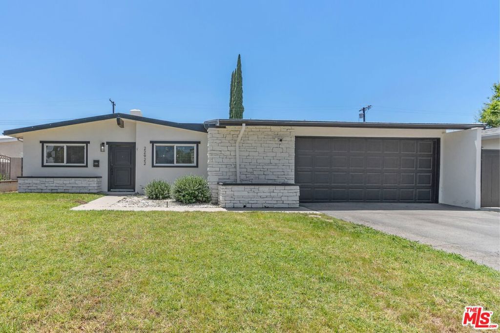 Welcome to this beautifully remodeled 3 bed, 2 bath home in West Hills. Pride of ownership is felt throughout in this home that is move-in ready and remodeled in 2021. Step inside to be welcomed by vaulted ceilings and a spacious family living room with a cozy fireplace. The open living space features ample natural light, recessed lighting, and newer engineered hardwood floors. The updated kitchen includes stainless steel appliances, a bar-style countertop, and custom built-in cabinets with wine refrigerator in the dining area for extra storage. The primary bedroom offers custom closets, a built-in TV, and an attached bathroom. Two additional bedrooms are generously sized with easy access to a hallway bathroom. The kitchen connects seamlessly to the dining area, living room, and lanai, perfect for indoor-outdoor California living. Enjoy a large lanai for shade, a customizable outdoor landing space, and a spacious, securely fenced backyard, ideal for Summer BBQ season. Direct alley access provides extra parking or flexible backyard options. The 2-car garage, accessible from the lanai, includes laundry and additional built-in storage. Roof was recently updated as well. Located just minutes from premier shopping destinations like Trader Joes, Walmart, Target, Costco, Westfield Topanga & The Village, the Calabasas Commons, Warner Center, the Rams training facility, the upcoming Woodland Hills stadium, and offers easy access to the 101 freeway and UCLA West Hills Hospital.