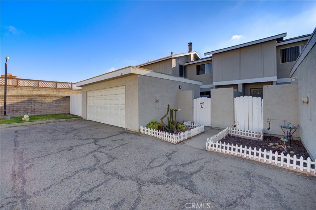 Charming Corner Unit in the Heart of Santa Maria! Welcome to 606 E Newlove Drive Unit L – a delightful 2-bedroom, 2-bathroom PUD nestled in a quiet corner of a well-maintained community. Ideally located near schools, parks, restaurants, and quick highway access, this home offers the perfect blend of comfort and convenience. As you approach the front entry, a quaint little patio space sets the tone — ideal for your favorite plants or seasonal decor. Step inside and you’re greeted by an inviting open-concept living room featuring a stylish black tile fireplace that adds both warmth and character. A handy under-staircase closet offers additional storage to keep things tidy. The adjacent dining area opens to a private, fully fenced backyard through a sliding glass door — perfect for weekend BBQs, relaxing evenings, or entertaining guests. The cozy kitchen boasts sleek white Corian countertops, wood cabinetry, and flows seamlessly into a convenient laundry area. A guest-friendly half bath completes the downstairs layout. Upstairs, you’ll find two comfortable bedrooms and a full bathroom. The first bedroom includes a walk-in closet and soft carpet underfoot, while the larger second bedroom offers dual closets and its own vanity sink. The shared bathroom features a separate vanity space and a tub/shower combo.
Enjoy the added benefit of a 2-car garage — ideal for storing cars, tools, or beach gear. On those warm summer days, take advantage of the sparkling HOA-maintained pool just steps away. Whether you're a first-time buyer or savvy investor, this charming home checks all the boxes. Come see for yourself why 606 E Newlove Drive Unit L is the ideal place to call home!