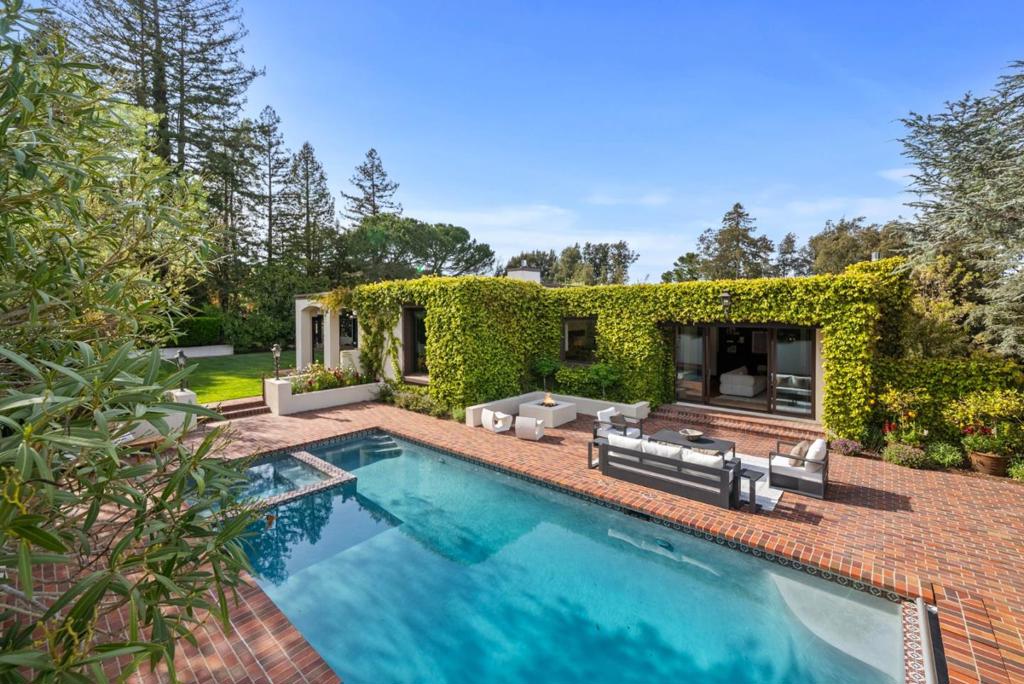 In the Burlingame Country Club area, this stunning renovation combines chic sophistication with Spanish flair. Featuring 5 bedrooms and 5.5 baths across two levels, the home has espresso-hued hardwood and Saltillo tile floors complemented by updated lighting, 3 fireplaces with modern style. The floor plan features upstairs living areas and the primary suite opening to the resort-inspired rear grounds, along with two additional bedroom suites. Two bedrooms on the entrance level share a bath. Formal living and dining rooms give way to a remodeled kitchen and family room that includes a study center, and all baths are remodeled with designer touches. Fig-covered walls envelop the wraparound loggia leading to glorious rear grounds with solar-heated pool and spa, heated cabana with barbecue kitchen, fireplace, media, & full bath plus level lawn and built-in trampoline. Ideally positioned midway between Silicon Valley & SF, with minutes-away proximity to SFO and top-rated Hillsborough public & private schools. Open Homes Photography measured the home at 4,784SQFT, 5 BD & 5.5BA. Buyer is to verify and satisfy themselves with square footage, lot size, BD & BA count.