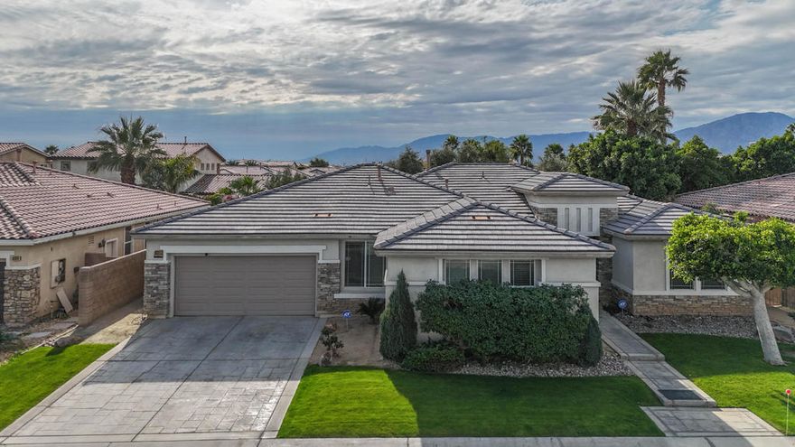 Live where convenience meets desert beauty in this spacious, single-level home located in the well-established gated Shadow Ranch community in North Indio. Shadow Ranch is a neighborhood of approximately 200 homes, featuring a small park and low HOA fees and special assessments in the property taxes. With 4 bedrooms, 3full bathrooms, and 2,749 square feet, this thoughtfully designed residence offers the ideal balance of comfort, functionality, and relaxed desert living.From the moment you arrive, the home impresses with manicured, lush green lawn landscaping and excellent curb appeal. Upon entry, a welcoming foyer with 10-foot ceilings sets the tone, creating an airy and inviting first impression.Enjoy southern exposure and spectacular mountain views from your private covered patio--perfect for morning coffee, sunset gatherings, or quiet evenings under the desert sky. Just blocks away, you'll find shopping, scenic hiking trails, and The Lights at Indio Public Golf Course, making it easy to embrace an active, outdoor lifestyle.Inside, the open, hosting-friendly floor plan flows beautifully and is ideal for both everyday living and entertaining. Highlights include a formal dining room, a generous bonus room/den, and a welcoming living area anchored by a tiled fireplace. The bright breakfast nook opens to the kitchen, which offers ample cabinetry, a five-burner cooktop, and all appliances--perfect for casual meals and weekend hosting.The floor plan is especially well designed for privacy, with excellent separation between bedrooms. One bedroom is located near the front entrance ideal for guests or a home office. Two additional bedrooms are situated near the bonus room/den, offering flexibility for family, guests, or multi-purpose living.The spacious primary suite is a true retreat, featuring a private patio entrance, a large walk-in closet, dual vanities, a soaking tub, and a separate shower. The private backyard is designed for easy enjoyment with a covered patio, fenced dog run, and plenty of space to relax or entertain. Additional conveniences include a laundry area, a two-car Enjoy single-level living with mountain views and a convenient North Indio location--set within the gated Shadow Ranch community.