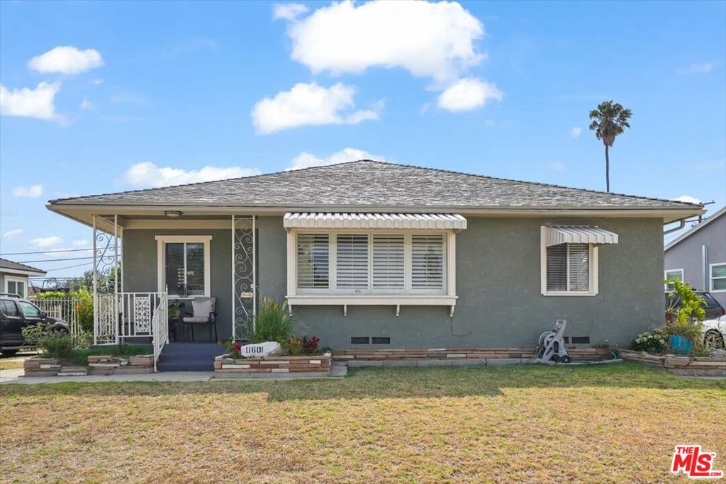 Welcome to 11601 Simms Ave, a beautifully upgraded home situated on a spacious 7,123 sq ft lot in the heart of Inglewood! This charming 2-bedroom, plus family room, residence offers comfort, functionality, and modern finishes throughout. Featuring laminate flooring, recessed lighting, and a bright open layout, this home is perfect for entertaining or relaxing with family. The remodeled kitchen is a standout, featuring shaker-style cabinets, quartz countertops, a custom backsplash, and stainless steel appliances. Enjoy meals in the formal dining area or at the breakfast bar. The large en-suite offers a peaceful retreat, and both bathrooms have been tastefully updated. A permitted 300 sq ft addition (2023). Additional features include new plumbing, a tankless water heater, a dedicated laundry room, and French doors off the family room that open to a generous backyard perfect for summer BBQs, family gatherings, or even future expansion. The detached garage offers ADU potential, adding value and flexibility to the property. This property qualifies for the Citi National Bank Ladder Up Grant, offering $20,000 toward your down payment, closing costs, or interest rate buy-down (subject to lender approval). Conveniently located a short distance to Crenshaw Imperial Plaza (Planet Fitness, Jamba Juice, grocery stores) and just minutes from Sofi Stadium, Kia Forum, Hollywood Park Casino, and major freeways. A rare opportunity on a large lot. Schedule your private tour today!