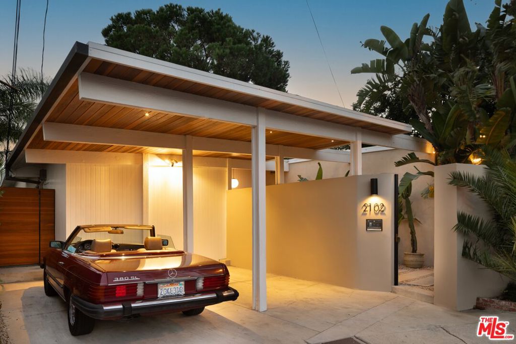Introducing 2102 Ridgemont, a rare Mid-Century gem in the West Hollywood Hills. This one-of-a-kind, magical, single-story retreat sits at the end of a cul-de-sac, offering a stunning and creatively remodeled living space. Bathed in natural light, it evokes the tranquil spirit of Tulum and Bali, with expansive views of the surrounding hills and a peek at the city beyond. Gated for privacy, this serene sanctuary features original wood-beamed ceilings, a chef's kitchen with Calacatta marble, Wolf appliances, and poured concrete honed floors. The primary suite features a private jungle-esque patio, while the lush exterior includes a saltwater pool, spa, infrared sauna, fire pit, and an exterior projector. This home has been meticulously redone with the finest of materials and craftsmanship. Located in the coveted Laurel Hills, near West Hollywood, Sunset Strip, Studio City and in the Wonderland school district, this home is a blend of Mid-Century charm and modern sophistication, perfect for entertaining or relaxing. An opportunity like this is truly rare, and the furnishings are available for purchase to complete the entirety of the experience.