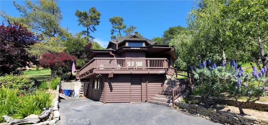 Big Sur style custom built Lodge Hill Hideaway. A Licensed Vacation Rental! Wood interior with Cedar beams, partial glass ceiling, skylights and Shoji screens throughout. Wooded views and wrap around deck for outdoor enjoyment. There are three bedrooms & two bathrooms and a wood burning stove in living area with built in seating. Private sunny backyard patio provide outdoor living space. Indoor laundry in lower storage room/possible workshop or living area. Appliances and a soft water system included. Enjoy peace and quiet where wildlife abounds. Offered for $899,000.