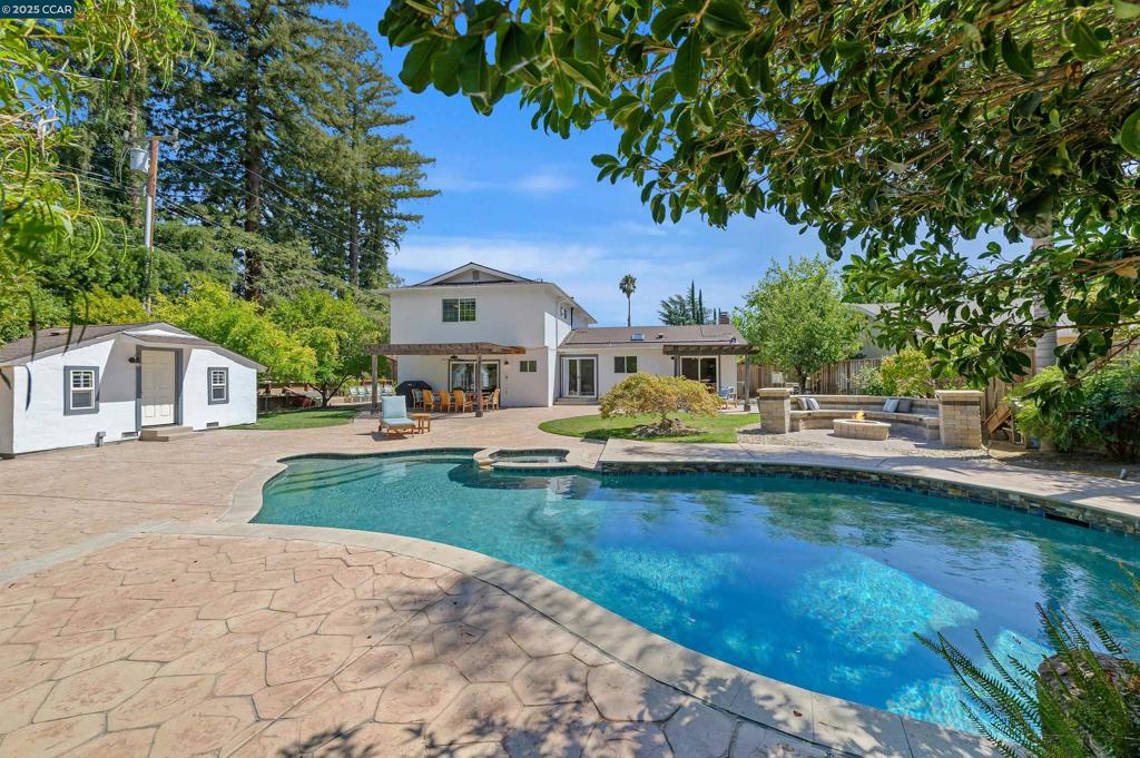 Open Sat 9/13 and Sun 9/14 1-4pm....Welcome to this stunning two-story home nestled in Walnut Creek’s desirable Carriage Square neighborhood. Set on a nearly quarter-acre lot, this 4-bedroom, 2.5-bath residence features an updated kitchen with stainless steel appliances, recessed lighting and plenty of natural light throughout. The inviting front yard boasts five mature rose bushes, maple trees, custom-stamped concrete with a charming sitting area, updated stone accents, a newer driveway, and a redwood fence for privacy. Located on a quiet, cul-de-sac street, this home offers both tranquility and convenience—just a short walk to local shops, restaurants and Carondelet and De La Salle High Schools. Three sliding glass doors lead to a backyard designed for relaxation and entertaining. Enjoy the sparkling, solar-heated pool and hot tub, surrounded by low-voltage lighting, mature fruit trees—including orange, pomegranate, cherry, tangerine, and apricot—and two beautiful redwood pergolas. A gas fire pit sets the perfect evening ambiance, while the detached pool shed doubles as a cozy she-shed or storage space. Fully owned solar system and well water for irrigation result in very low utility bills This is the perfect home to experience the best of California indoor-outdoor living.
