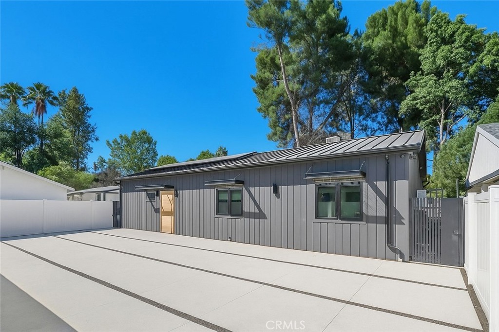 Tucked away at the end of a long private driveway, this beautifully renovated home in the coveted Walnut Acres neighborhood of Woodland Hills offers the perfect balance of modern luxury and everyday comfort. Soaring ceilings, skylights, and walls of glass fill the interior with natural light, seamlessly connecting the open-concept kitchen, living, dining, and den to the outdoors—an ideal flow for both relaxed living and entertaining. The spacious primary suite provides a serene retreat with generous closet space, while two additional bedrooms offer flexibility for family, guests, or a dedicated home office. Outside, the private backyard is designed for year-round enjoyment with low-maintenance turf, multiple seating areas, a built-in BBQ zone, and plenty of space to gather or unwind. Additional highlights include solar, an expansive driveway, and unmatched privacy. All this in a prime location close to Westfield Mall and Village, Calabasas Commons, Warner Center, and zoned for the highly rated El Camino Real and Hale Charter schools. This Walnut Acres gem delivers style, space, and convenience in one of the Valley’s most desirable communities.