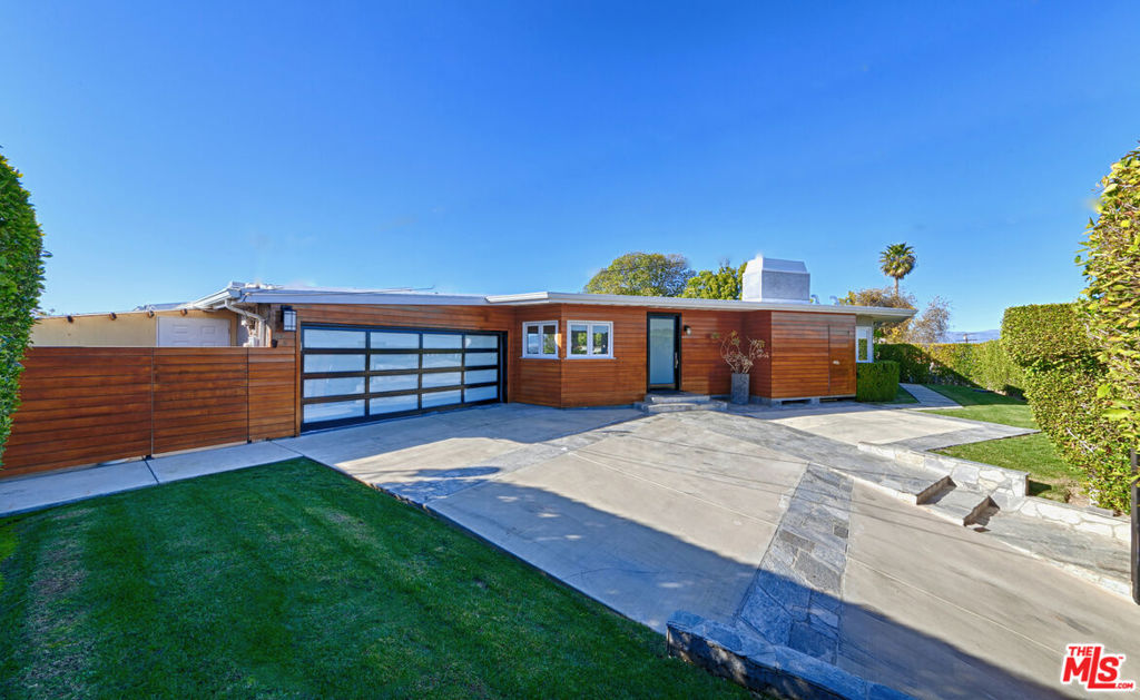 Discover this rare, remodeled single-level mid-century modern nestled on a fully fenced 3/4 acre lot in the coveted hills of Sherman Oaks. This entertainer's paradise offers a heated pool, an outdoor cooking area with built-in BBQ grill, multiple patios, manicured lawns, an array of fruit trees, and is surrounded by breathtaking valley and hill views. Step inside to an expansive open floor plan where the kitchen, living, and dining areas seamlessly blend with the back yard thanks to the floor-to-ceiling glass doors and windows that flood the space with natural light, epitomizing the idyllic Southern California indoor-outdoor lifestyle. The designer kitchen is a chef's dream, featuring stone countertops, a large center island, Wolf and Sub-Zero stainless steel appliances, dual sinks, and abundant cabinet space. Adjacent to the main living area are two spacious bedrooms and a large versatile bonus room which could easily serve as a third bedroom. The primary bedroom boasts floor-to-ceiling glass doors that open to the yard and pool, offering spectacular views. It includes extensive built-in closets and a private ensuite bathroom with a large steam shower. The bonus room features vaulted ceilings, a fireplace, as well as direct access to the yard and pool. Additional highlights include hardwood floors, recessed lighting, washer and dryer, central HVAC, two fireplaces, security system, two-car garage with built-ins, extra secured parking in the driveway, and a dog run. Perched in the coveted hills of Sherman Oaks and conveniently located near Mulholland, freeways, the valley, and the westside, this property is a must-see. Tenants are responsible for all utilities including gardener and pool maintenance. Don't miss this exceptional opportunity in a prime location.