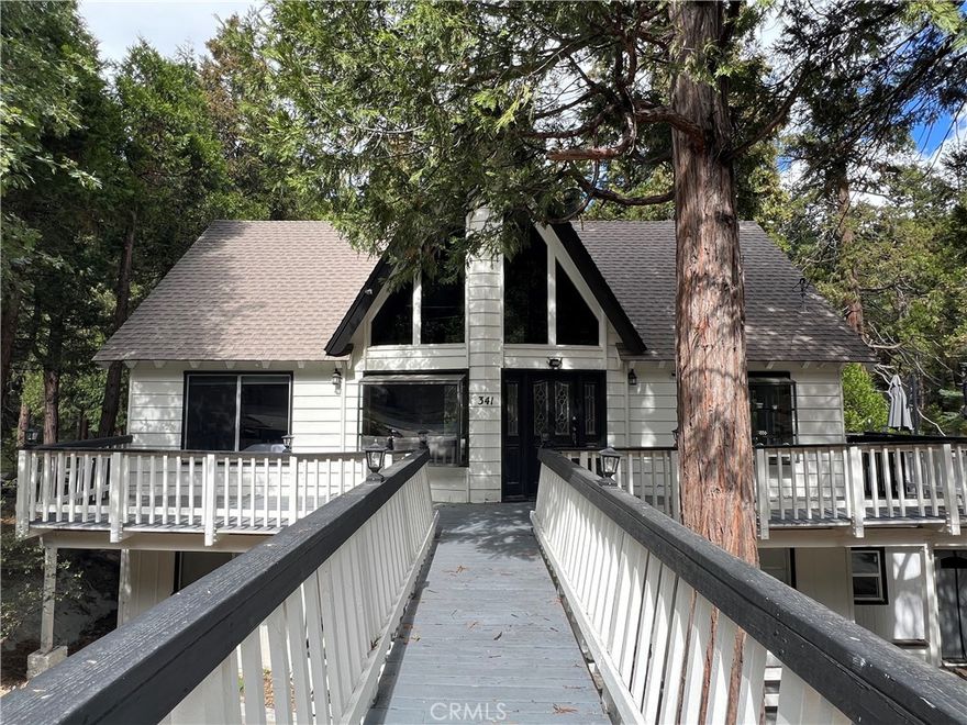 This 4-bedroom, 3-bath Thunderbird home offers level entry, a warm and inviting living room with a striking stone fireplace, and soaring vaulted ceilings with expansive windows.

Remodeled kitchen, outfitted with stainless steel appliances. The main-level primary suite provides comfort and convenience, while the lower level features two spacious bonus rooms, additional bedrooms, and baths—perfect for guests, family, or flexible use.

Step outside to your private backyard with a seasonal stream, ideal for peaceful mornings or al fresco entertaining. Oversized decks, ample parking, and a generous lot backing to untouched open space add to the sense of privacy and relaxation.

This turn-key property is ready for you to move in and start enjoying the Lake Arrowhead lifestyle, complete with access to the private lake—your perfect mountain escape awaits.
