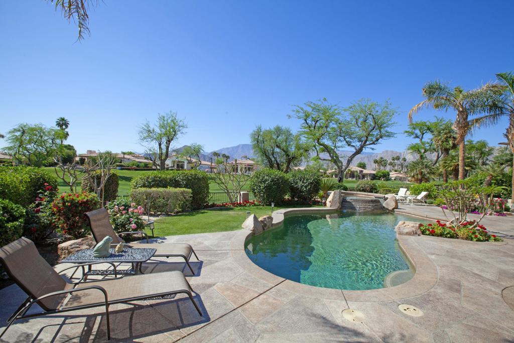 Gorgeous south facing Montana I floor plan with views of the Santa Rosa Mountain range and the 18th fairway of the Robert Trent Jones Jr. Championship Golf Course. The custom curvilinear pool is surrounded by the large entertainer's patio that has a beautiful overlay finish. The low fence at the property line will help keep man's best friend with you. Relax in the elevated custom stack stone spa or pull up a barstool by the outdoor BBQ. Located on a cul-de-sac street with beautiful curb appeal on a large lot. Come through the dramatic arch into the private courtyard that links the attached guest casita with the handsome dual-door entry. Inside you will find a wall of glass looking to the view from spacious great room. Whether dining, relaxing or having a cocktail, it's all a seamless experience in this floor plan. The large kitchen was remodeled in 2014 and features a center island, slab granite counters, Viking stove, KitchenAid refrigerator, dishwasher, Viking hood and beautiful waxed glass cabinet door fronts. The great room features a custom entertainment wall, stone tile fireplace, custom window coverings. The primary bedroom is a suite with mountain views, an opulent bathroom with dual sinks, large soaking tub, oversize shower and walk-in closet. Furnished per Inventory List. All bedrooms are en-suite. Two-car garage plus golf cart garage.