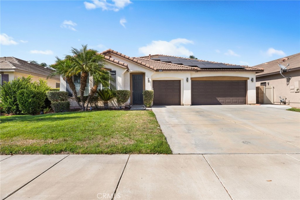 Step inside this light-filled single-story retreat in the heart of Menifee, where thoughtful updates and an open layout create the perfect blend of comfort and style. Upon entry, you're greeted by soaring vaulted ceilings and warm, updated flooring that flows seamlessly throughout the living and dining spaces. The heart of the home serves as a stunning focal point, anchoring both the formal living room and the cozy family room, ideal for evenings spent relaxing or entertaining. The spacious kitchen offers plenty of cabinetry, ample prep space, and a charming breakfast nook. The home features four generously sized bedrooms, including a tranquil primary suite with a walk-in closet and direct access to the backyard. Both bathrooms have been tastefully updated with modern finishes, offering a clean and fresh aesthetic. Step outside to your private yard where a covered patio invites you to unwind, dine al fresco, or host weekend barbecues. With a large grass area, the backyard offers privacy, openness, and potential to personalize, whether you envision a garden, play space, or peaceful retreat. Additional highlights include an efficient solar system, attached three-car garage, indoor laundry room, and an efficient floor plan that maximizes both functionality and charm. Located on a quiet street, this home offers easy access to schools, shopping, and both the 15 and 215 freeways. Whether you're commuting or simply enjoying all that Menifee has to offer, this home is a smart and stylish place to land. Don’t miss the opportunity to make this move-in ready home yours!