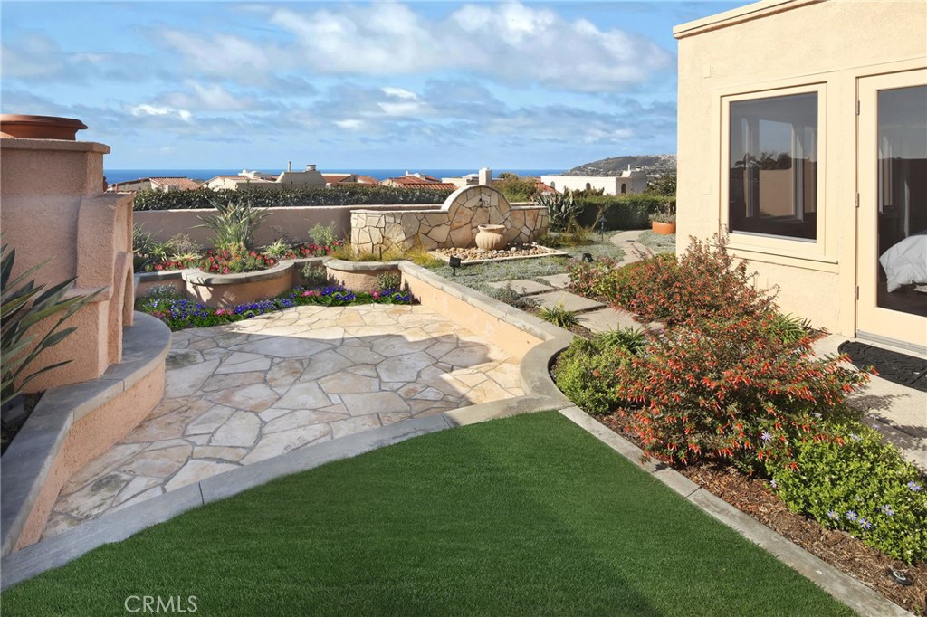 This Luxury single-level Mediterranean VILLA located in the gated oceanfront community of Niguel Shores near the Ritz Carlton Hotel, Links Golf Course, Salt Creek Beach and The Strands, the Dana Point Marina and the Art Colony of Laguna Beach features panoramic Ocean, Catalina Island sunset views, and coastal views to Palos Verdes. The property has been remodeled and expanded throughout and boasts a large dramatic entry, Great Room open concept design with fireplace and custom cabinetry with display lighting, a Chef's kitchen with stainless steel newer Dacor appliances, limestone counter tops, convection oven, warming oven and built in refrigerator plus large kitchen island with bar seating. In addition, there are 3 Bedrooms plus den/office, 2.5 Baths, and ocean views from all main rooms. The spacious primary suite with ocean view includes a newly remodeled bath with dual vanity sinks and quartzite counters, separate free-standing tub, walk in closets, and walk in steam shower. The all new hall bath includes designer tiles and finishes. The delightful floorplan includes vaulted ceilings, beautiful wood flooring, custom lighting, skylights, exceptional architectural woodworks, inside new laundry room, A/C, and a new custom walk in pantry plus an outdoor shower perfect after a day at the beach. The exterior includes a gated courtyard entry patio while the backyard provides the perfect serene spot to entertain and enjoy the amazing ocean and sunset views complete with an outdoor kitchen with built in BBQ and sink, outdoor fireplace and fountain. The finished two car attached garage includes ample loft storage with automated ladder and a half bath. The community of Niguel Shores spotlights an oceanfront blufftop park complete with direct beach access and parking lot, greenbelt trails and walkways, plus a lavish Clubhouse complete with Jr. Olympic size Pool, Spa, Pickle Ball, Tennis, Sport's Courts and Park. The community of Niguel Shores offers a multitude of activities and clubs from Bridge to Gardening, Golf, Tennis and more...Take the Trolley to Laguna or hike to the harbor and Dana Point shops, or relax and enjoy the ever-changing ocean and sunset views from your tranquil patio areas. Enjoy the fun and festive beach lifestyle all year around living in Niguel Shores...The "Best-Kept" Secret Along The Coast!