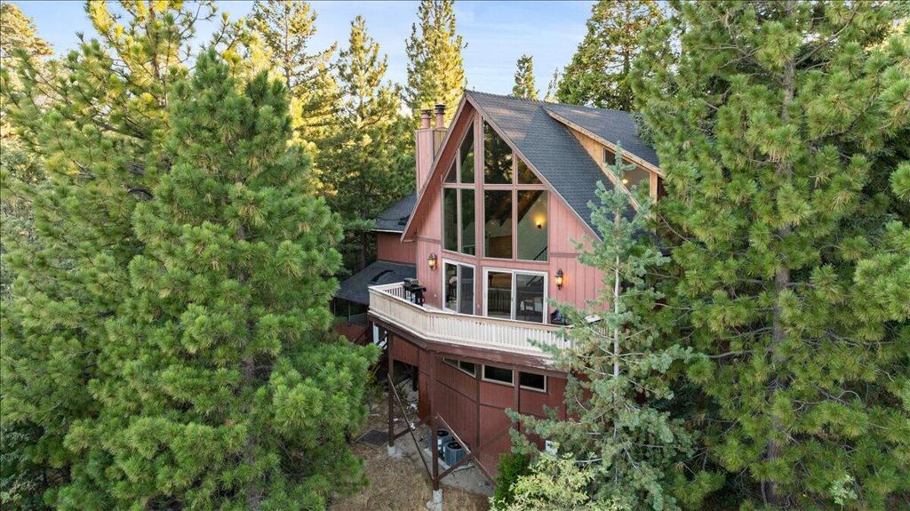 Remarkable Lake Arrowhead retreat perched high in the sought after North Bay neighborhood. Nestled among towering trees with a charming peek a boo lake view, this home offers both privacy and natural beauty. A spacious deck off the living room and covered patio on the lower level provide an inviting space to enjoy the sunshine and fresh mountain air. Step inside and you are greeted by dramatic, two story vaulted wood beamed ceilings, floor to ceiling windows and a stunning marble fireplace that anchors the living area. The remodeled kitchen features granite countertops, stainless steel appliances, a center island and a seamless connection to the living room forming a spectacular great room, perfect for entertaining and gazing at the tranquil views from every window! Featuring a large den/game room, separate laundry room, interior storage and master suite on the first level, two bedrooms and a bath on both additional levels, two car garage from entry level, dual pane windows, central air conditioning/heating and much more! Tucked away at the end of a cul-de-sac on a 10,230 square foot lot, this home offers rare privacy and serenity while still being just minutes away from the lake, restaurants and shopping centers. This is truly a must see mountain getaway!