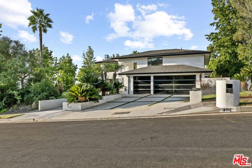 This beautifully updated home set on a spacious 17,487 sq. ft. lot, offers modern luxury, privacy, and panoramic views throughout. Located in the sought-after Lake Encino community, the residence welcomes you with lush landscaping, palm trees, and custom architectural lighting. Inside, a grand 17-ft foyer with hardwood floors and a glass-panel staircase leads to open-concept living spaces filled with natural light. This home includes 6 bedrooms, 4 bathrooms, custom executive office and much more. Doors open to a beautiful backyard featuring a custom pool and spa with Baja shelf, outdoor kitchen with Viking BBQ and Coyote appliances, elegant dining space, and low-maintenance, drought-conscious landscaping. The chef's kitchen is equipped with solid wood cabinetry, quartz countertops, Sub-Zero refrigerator and freezer, and premium Viking appliances. The open layout flows into a spacious living and dining area with fireplace and recessed lighting. HOA amenities include private tennis courts. Optional roaming security available via third-party provider.